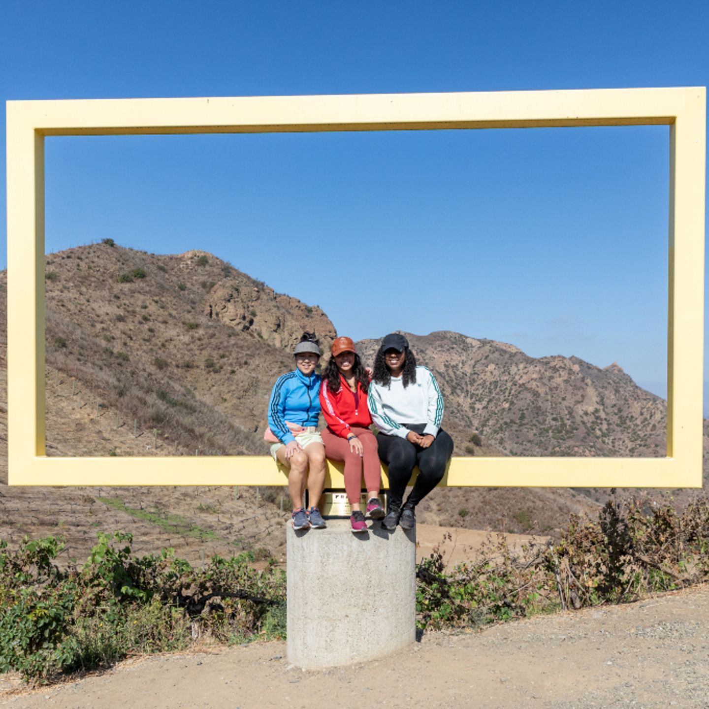 3 people taking photo in frame