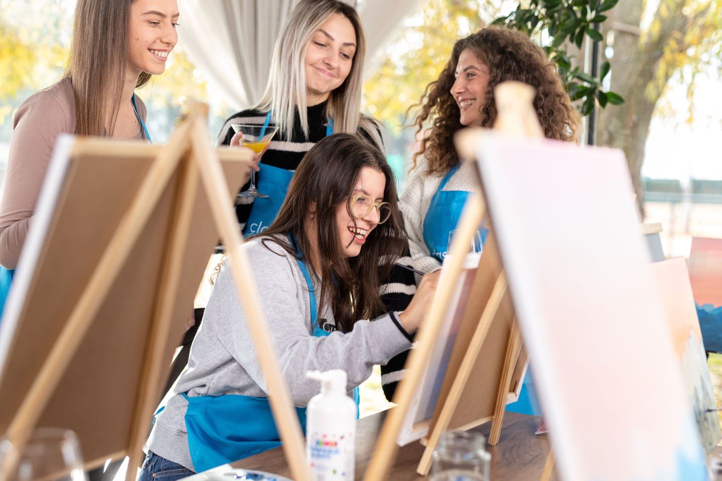 Friends watching girl paint