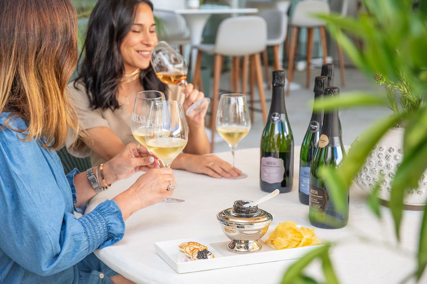 Two people enjoying wines and bites