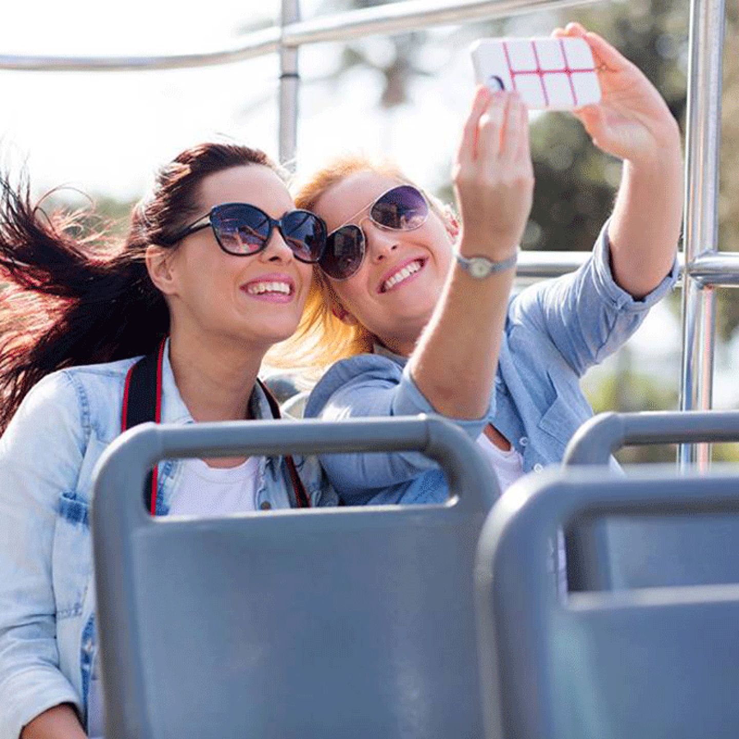 Two women taking a selfie on a bus tour