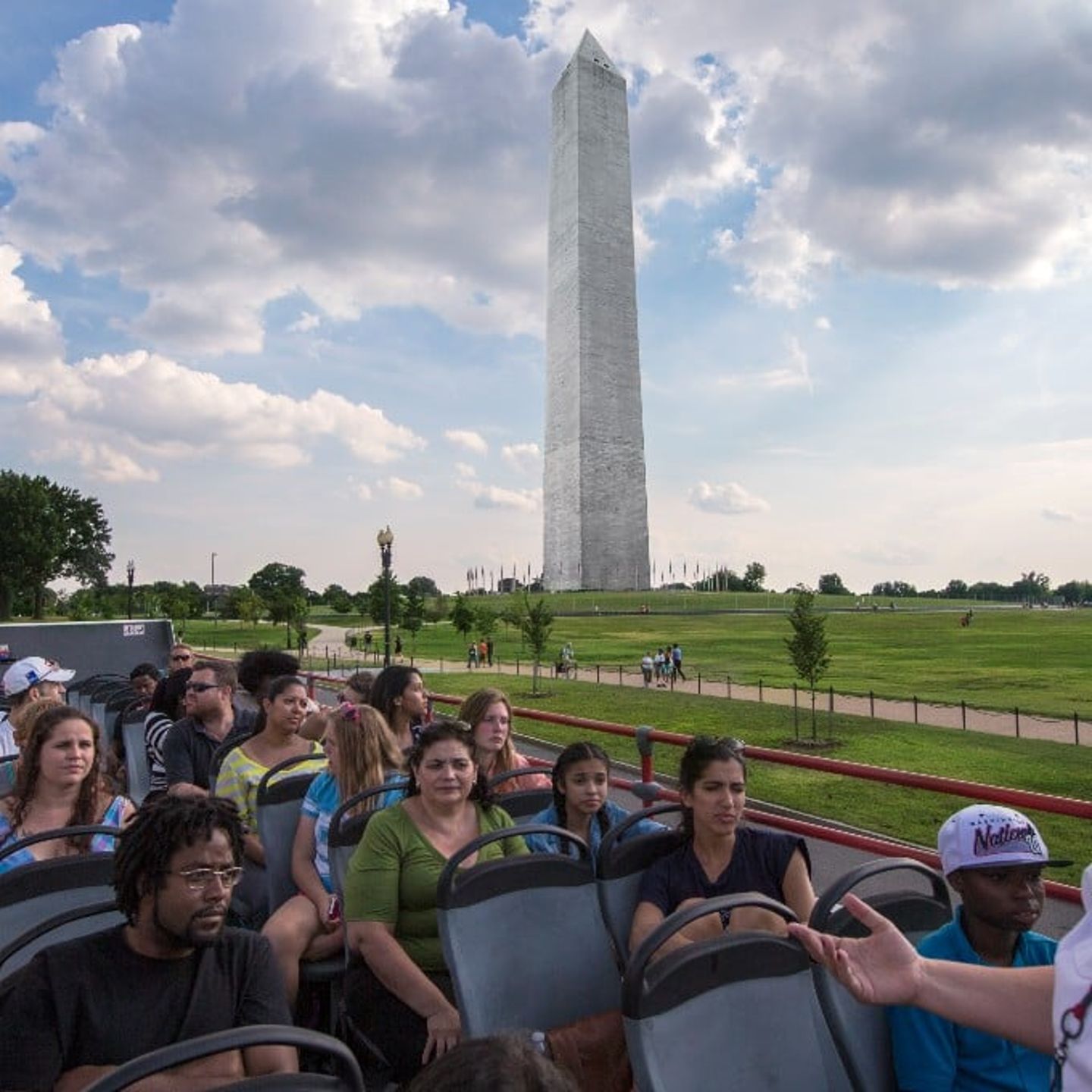 People in bus in front of monument