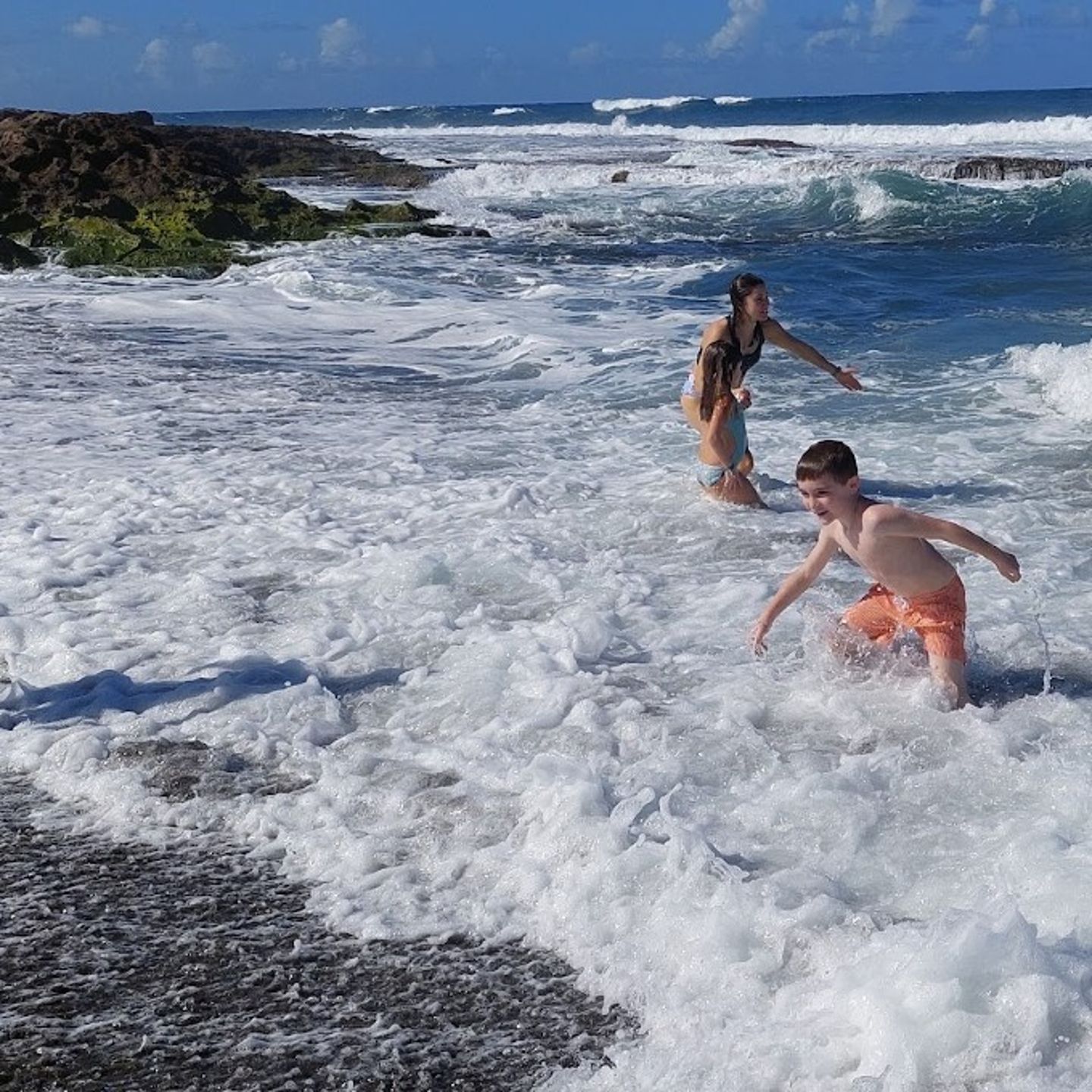 People Playing on Black Sand Beach