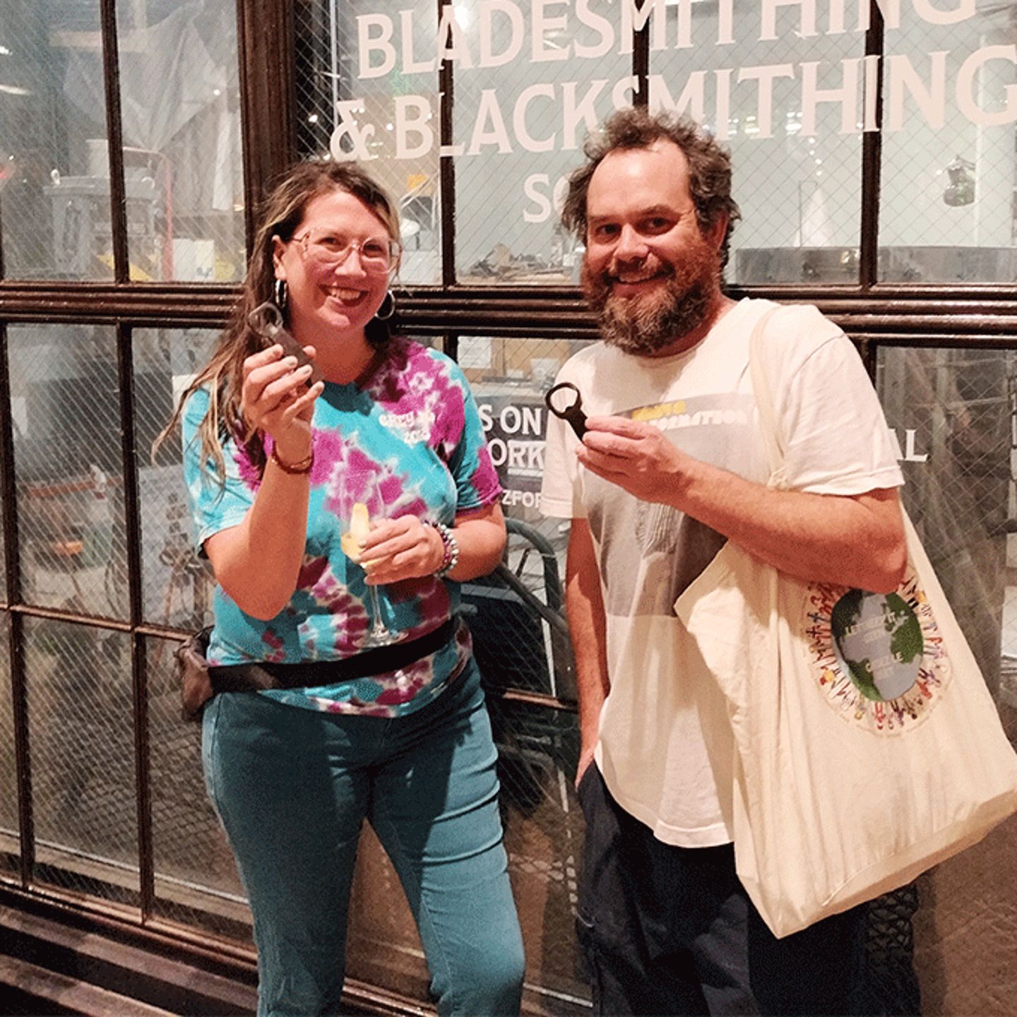 Two people holding bottle opener