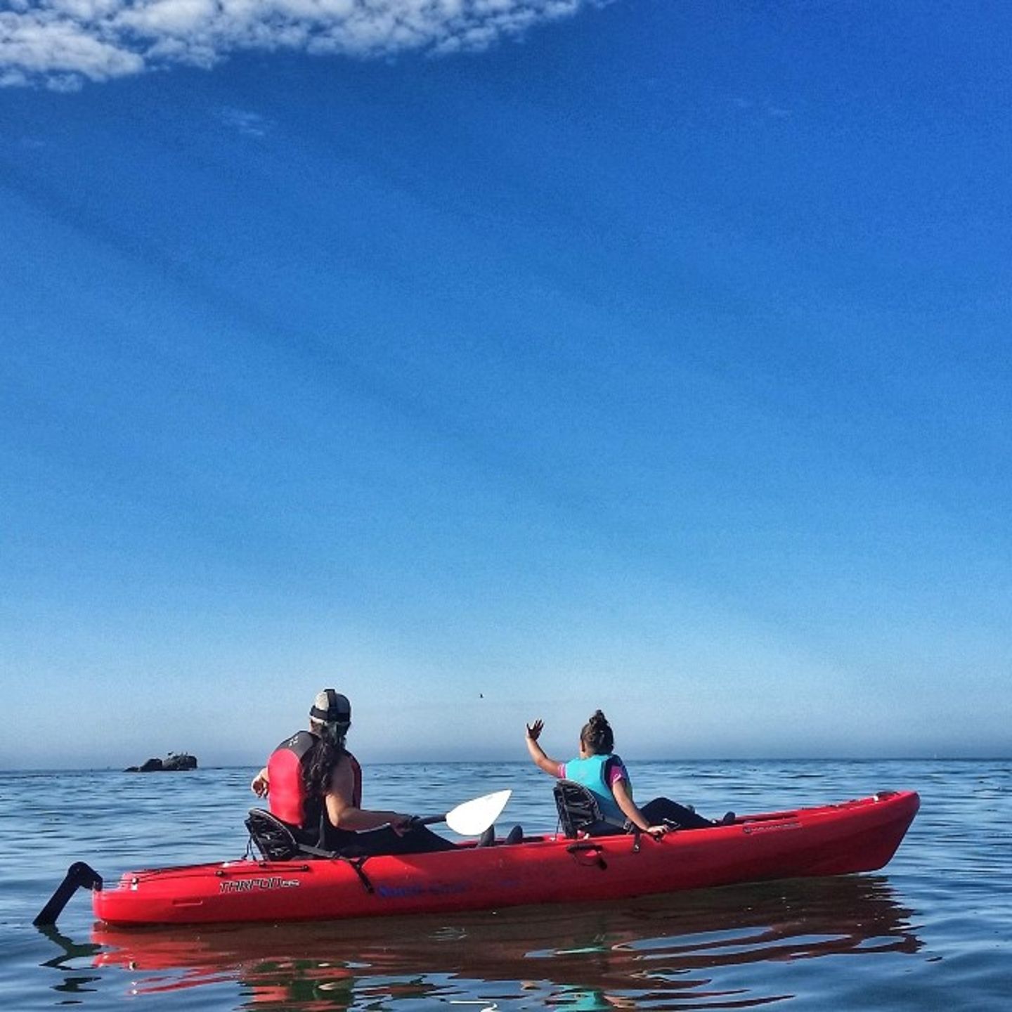 Two people in kayak on ocean