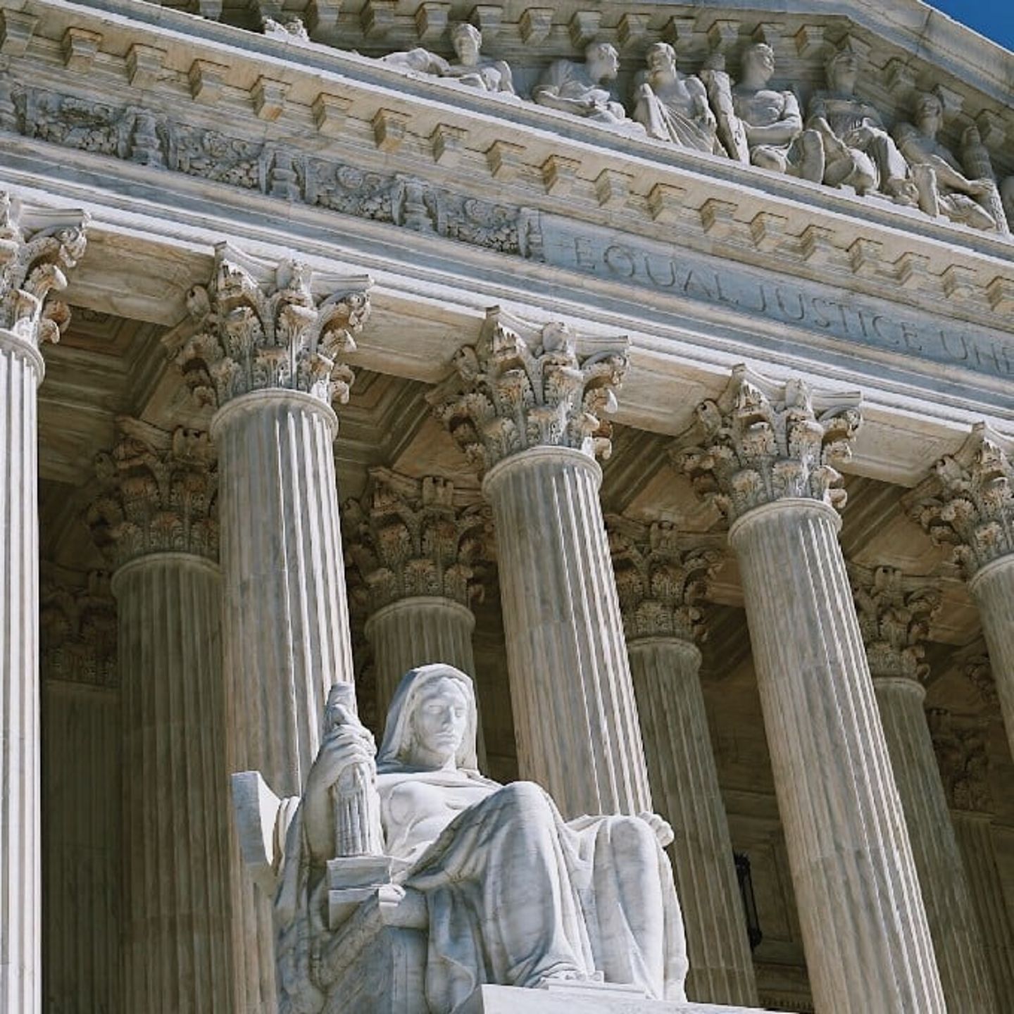 Statue With Building in Background