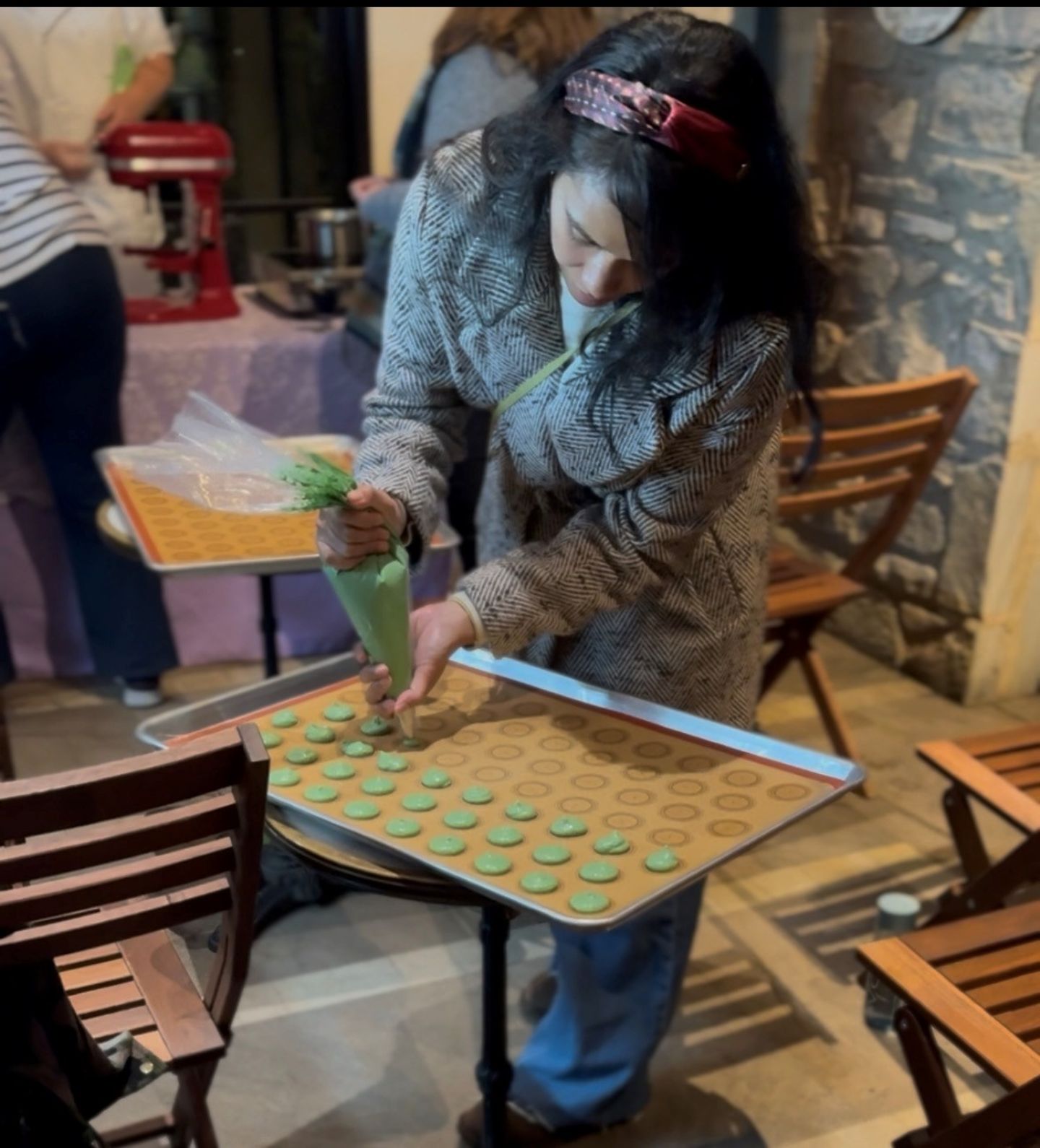 Woman piping macarons
