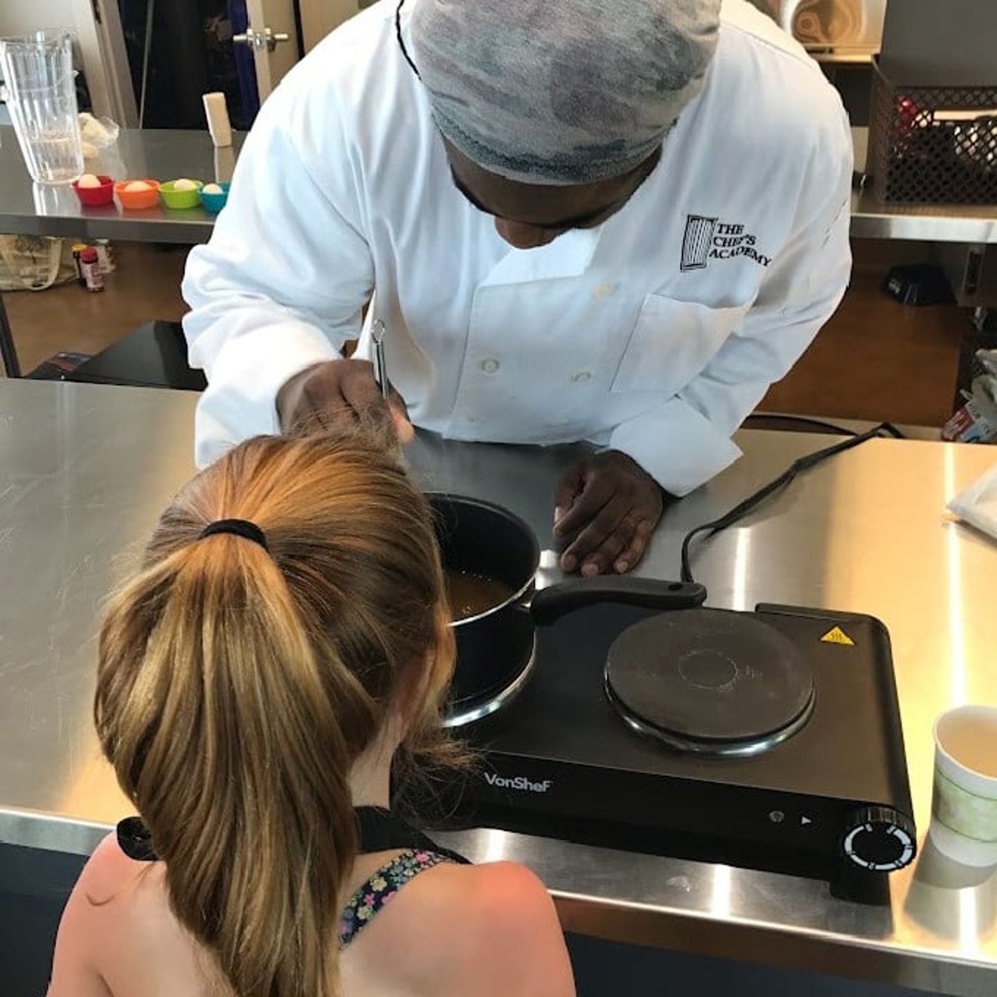 Kid cooking with chef