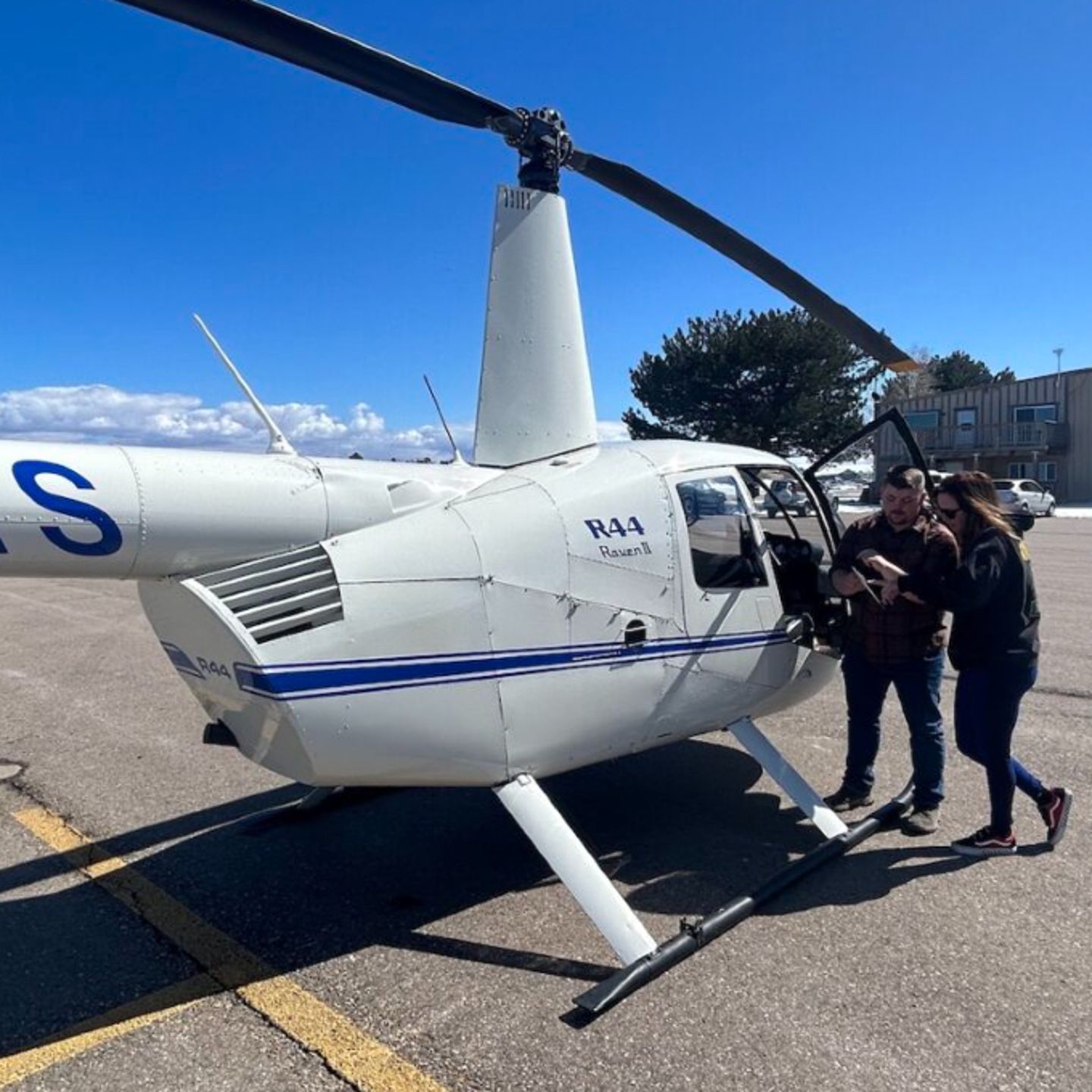 People next to helicopter