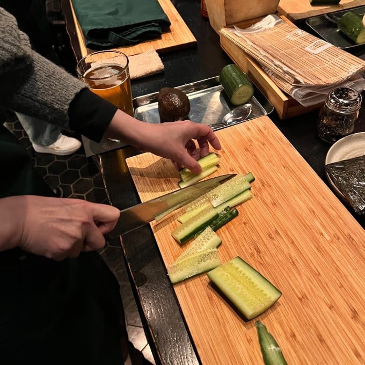 Person cutting cucumber