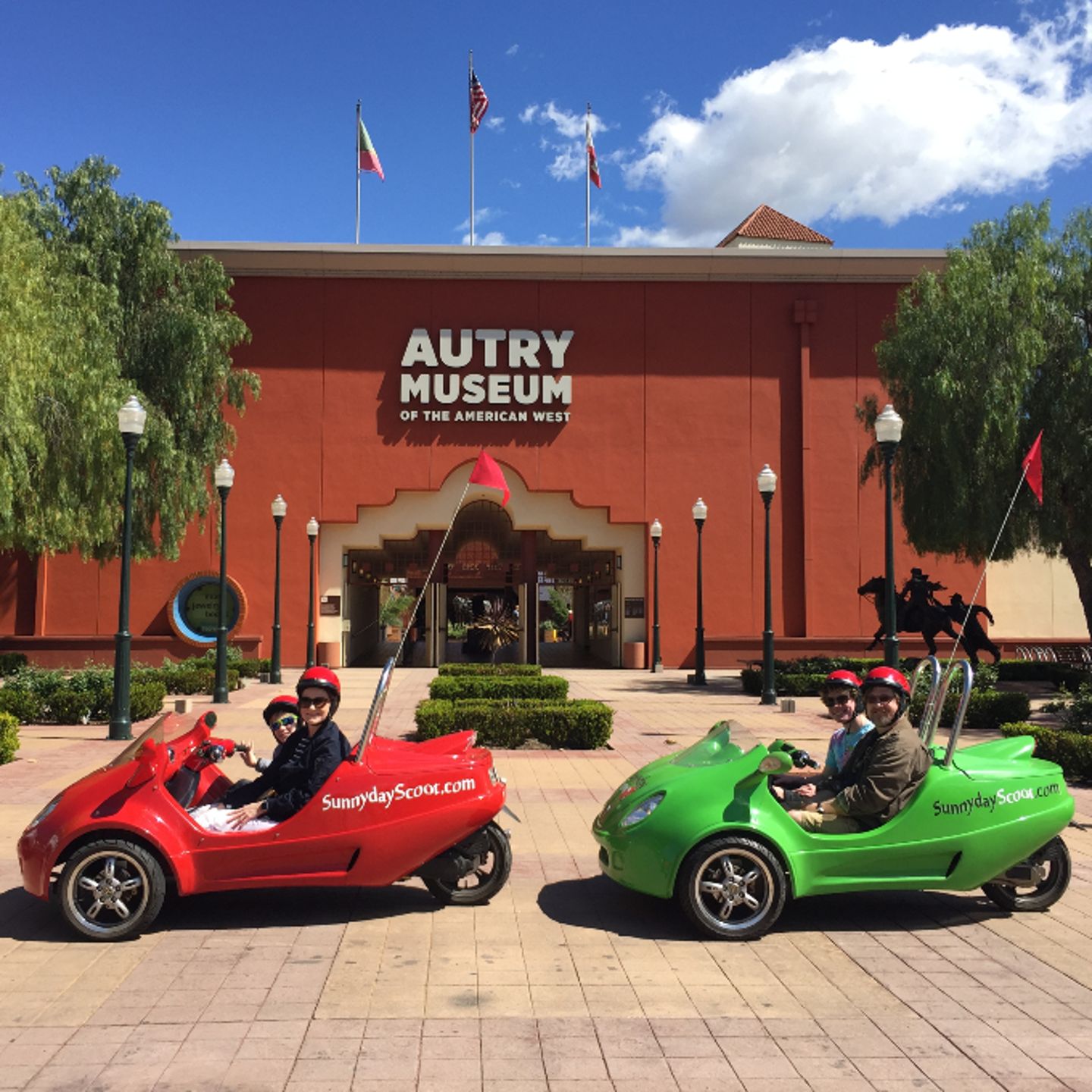 Two cars in front of museum