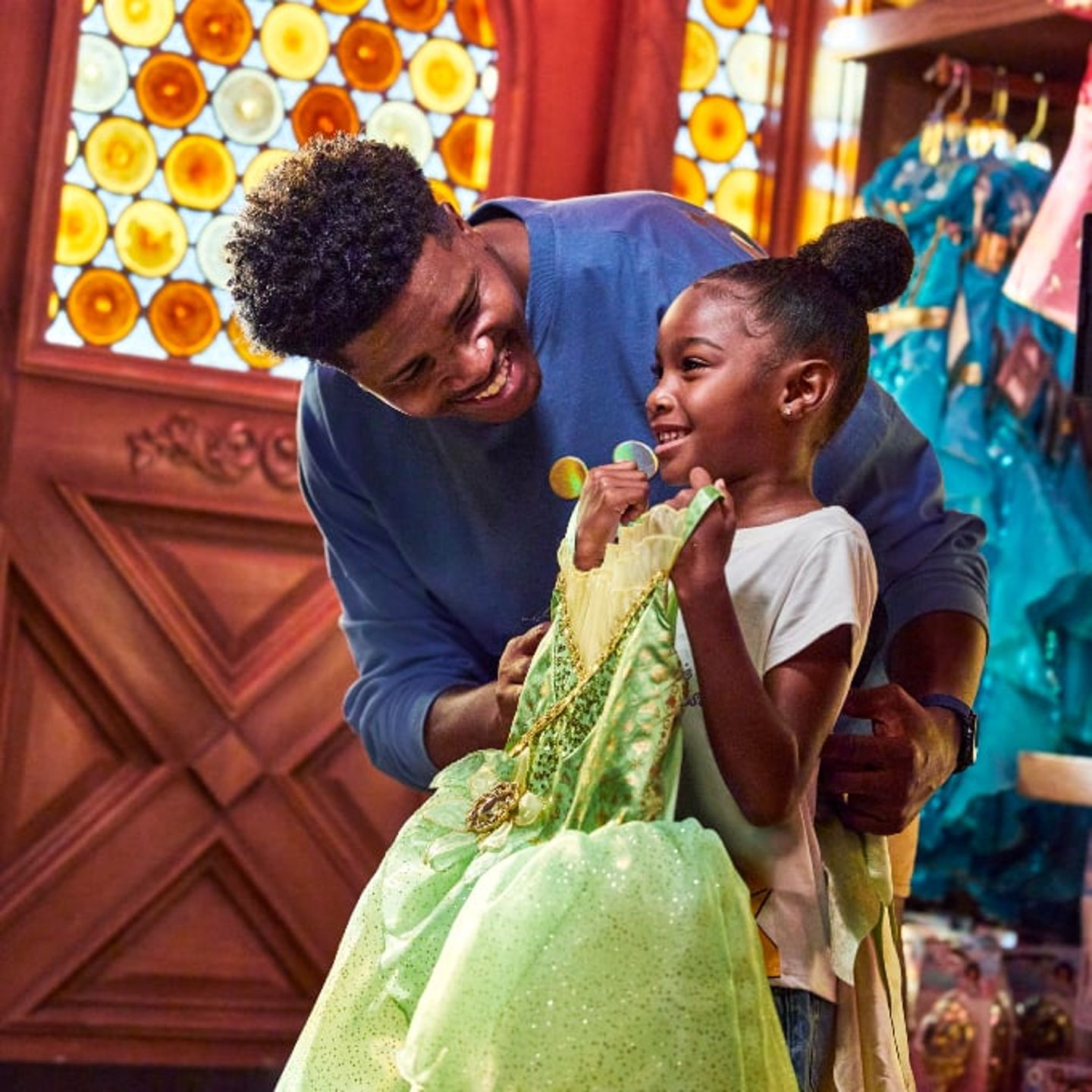 Girl picking out ©Disney princess dress