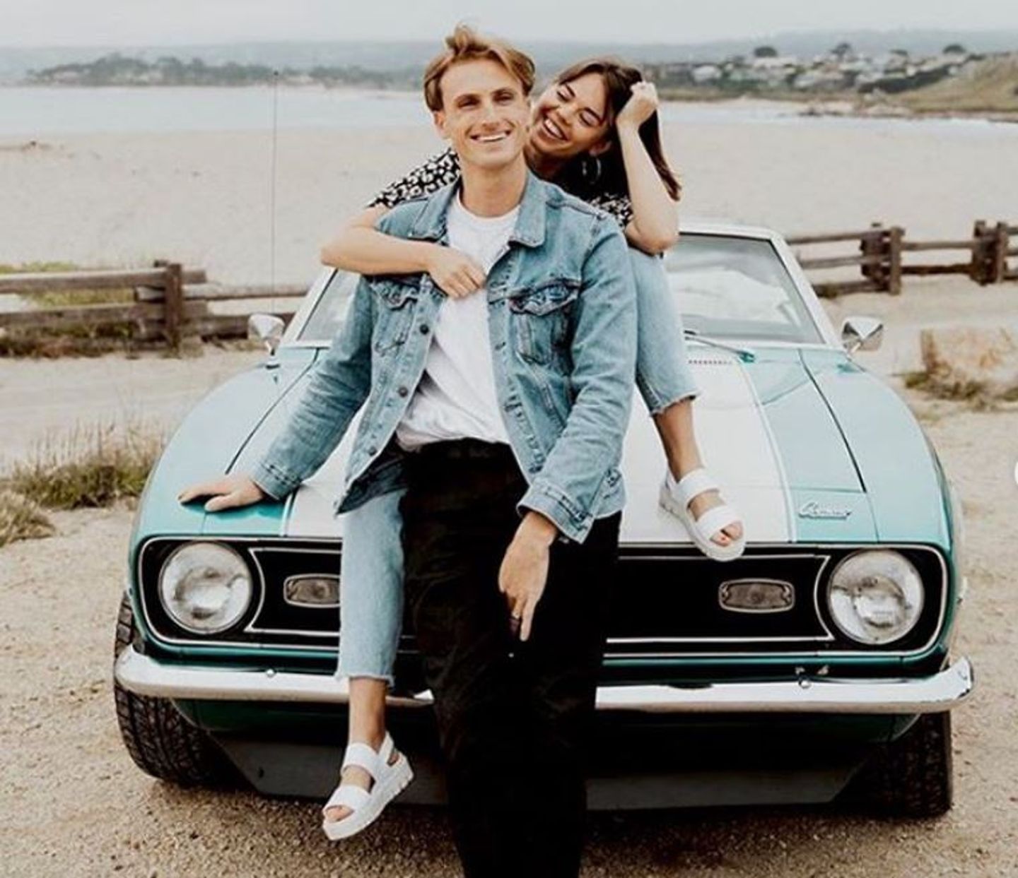 Couple sitting on car