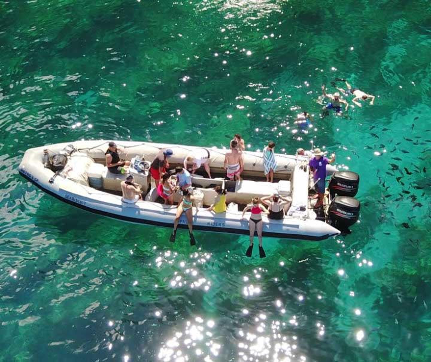 People snorkeling off raft