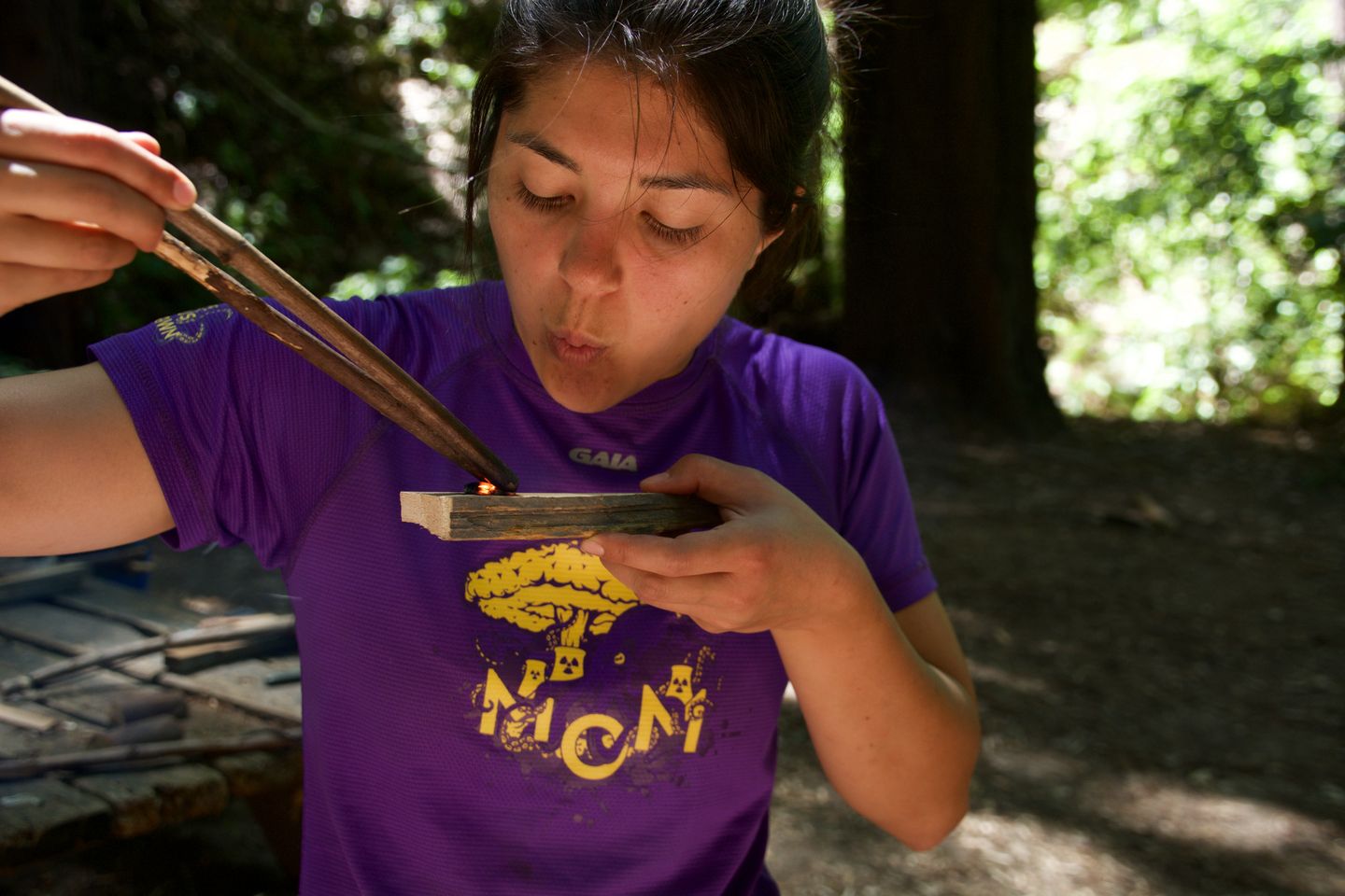 Woman blowing on flame