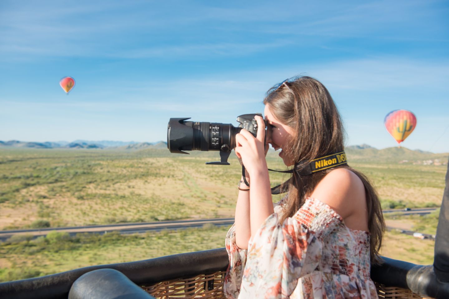 Woman taking photos from balloon