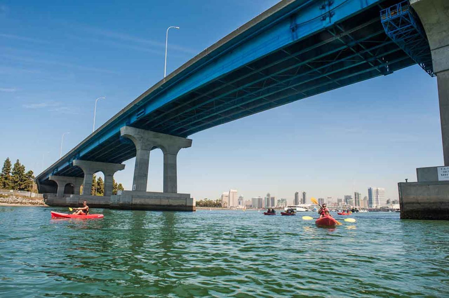 Kayaks under bridge