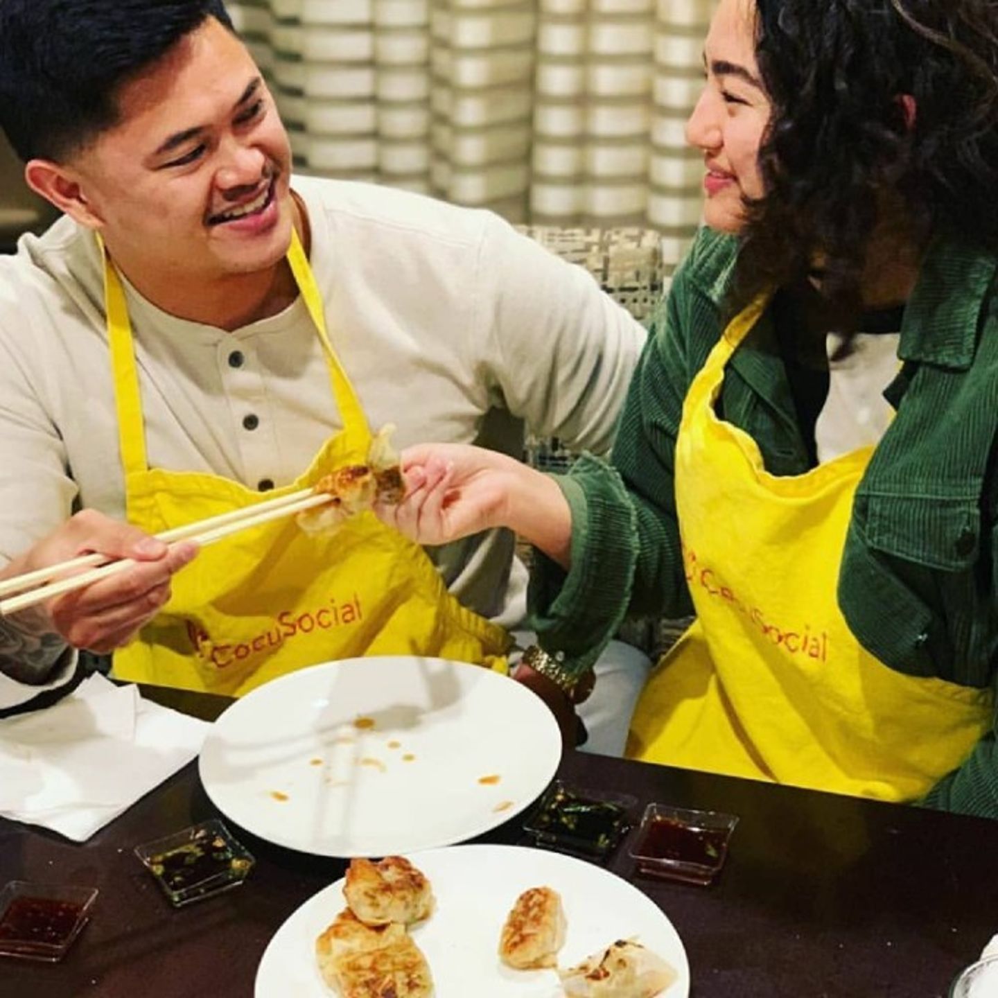 Two people eating dumplings