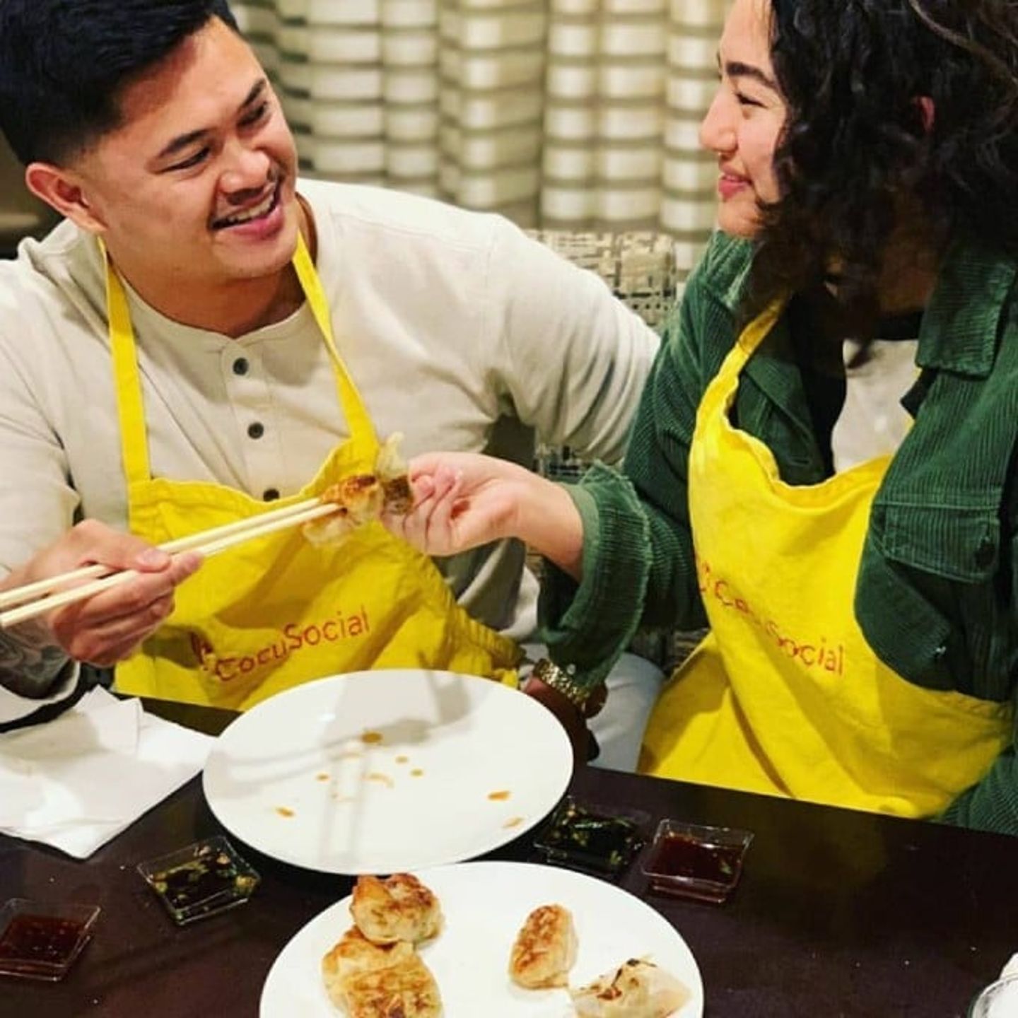 Two people eating dumplings