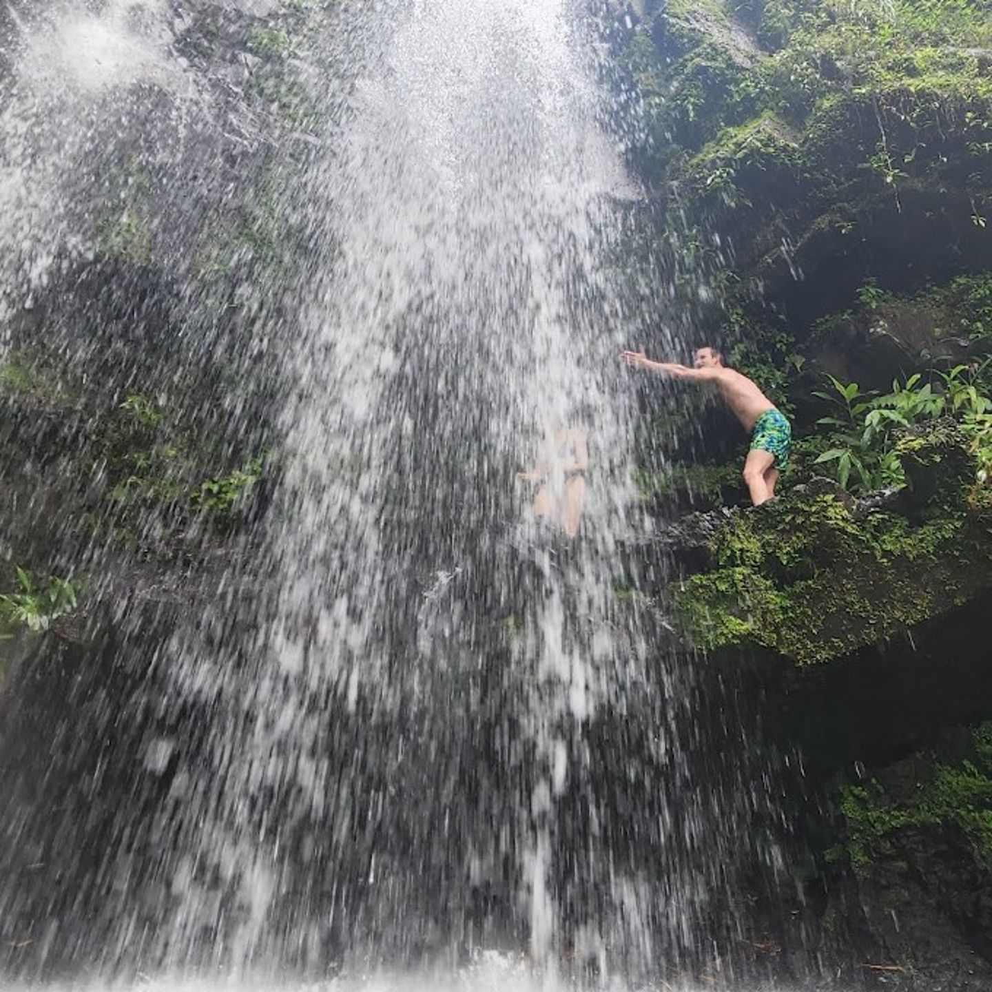 Man Jumping into Waterfall