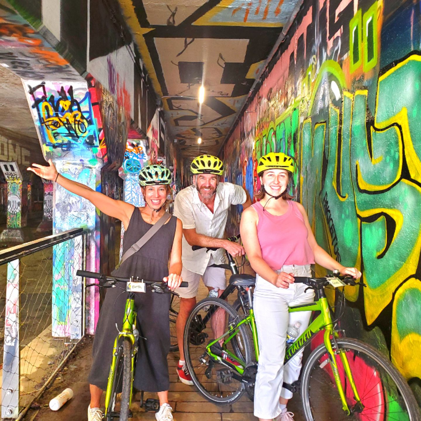 People next to graffiti art