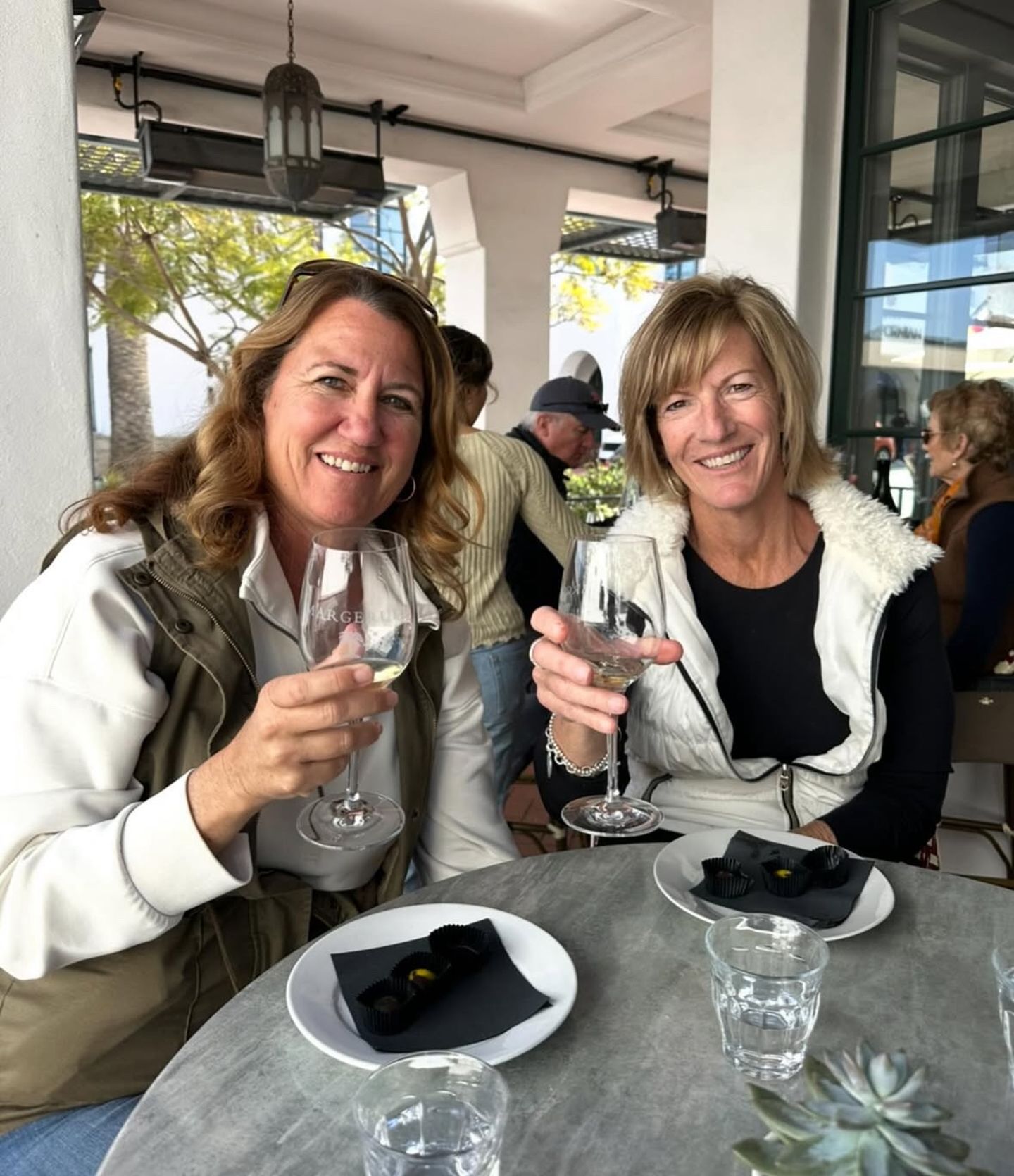 Two people with wine and chocolate