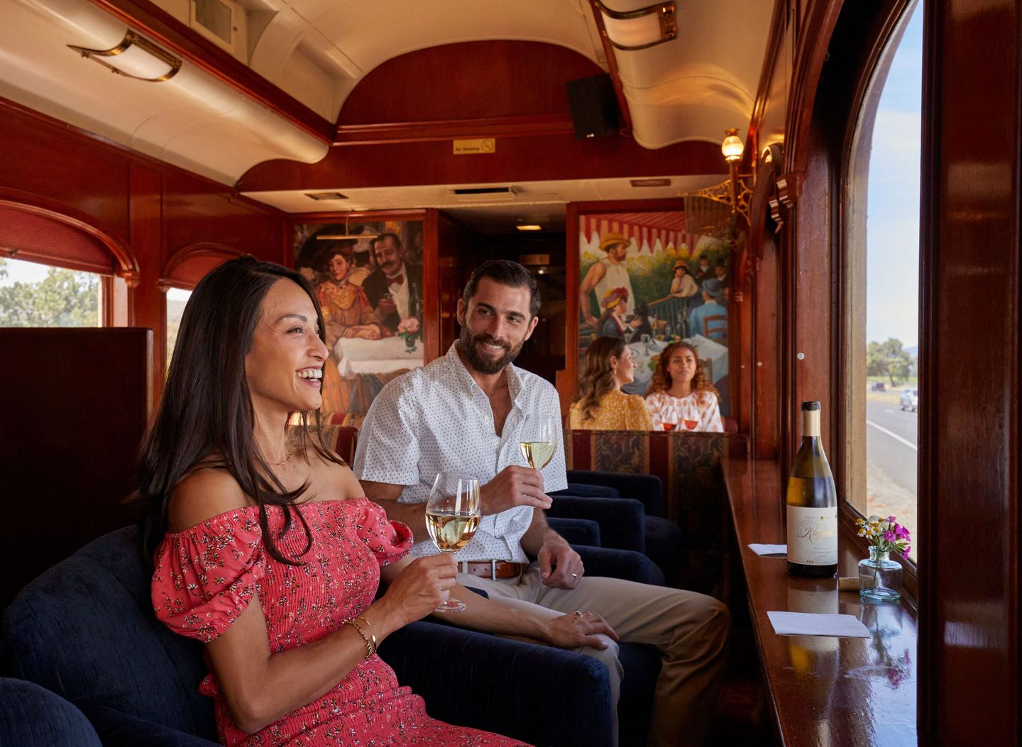 Couple drinking wine on train