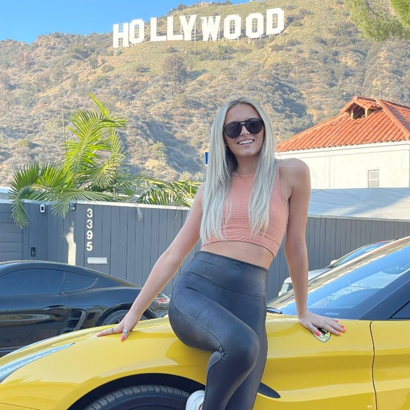 Woman sitting on car