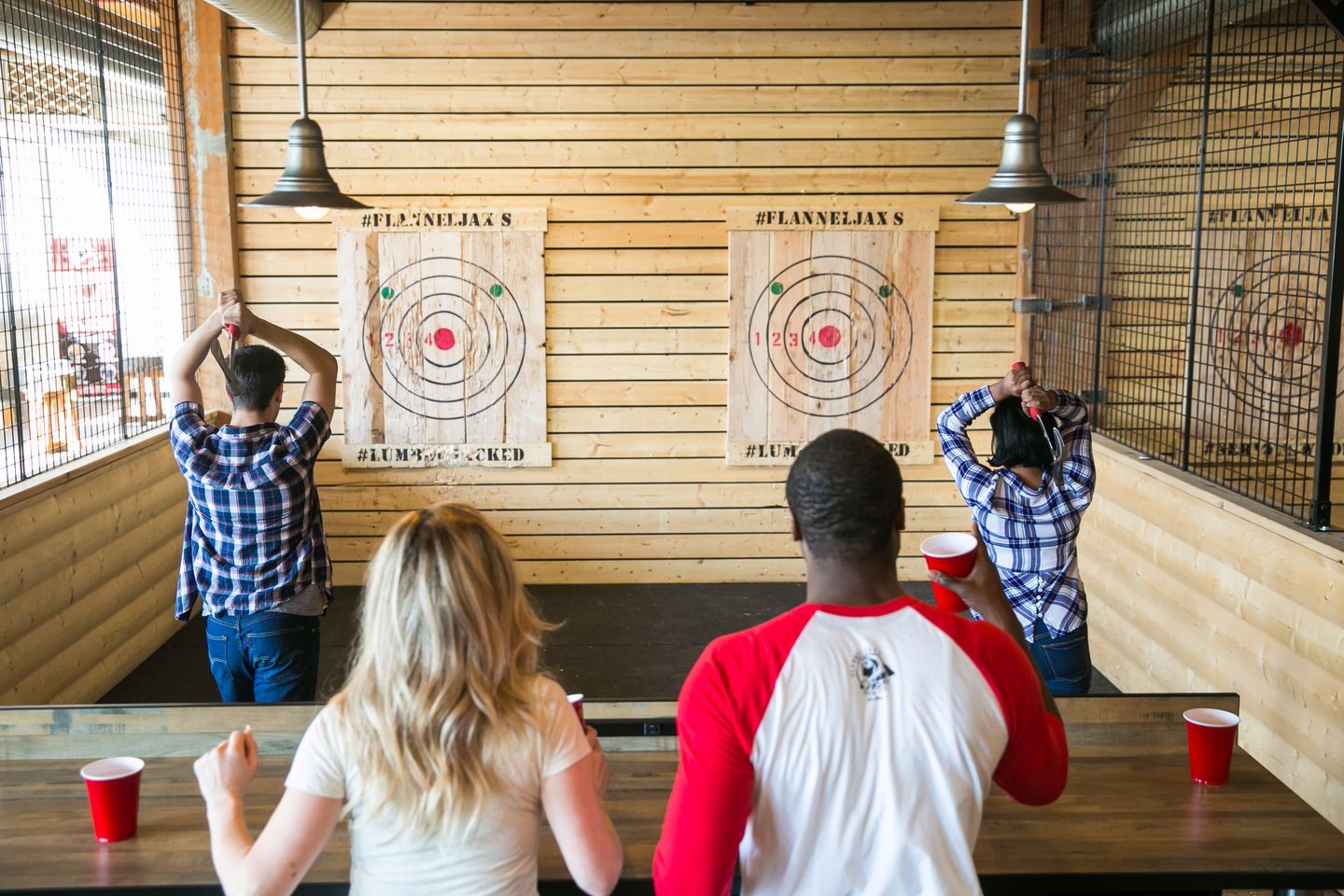 Two people throwing axes