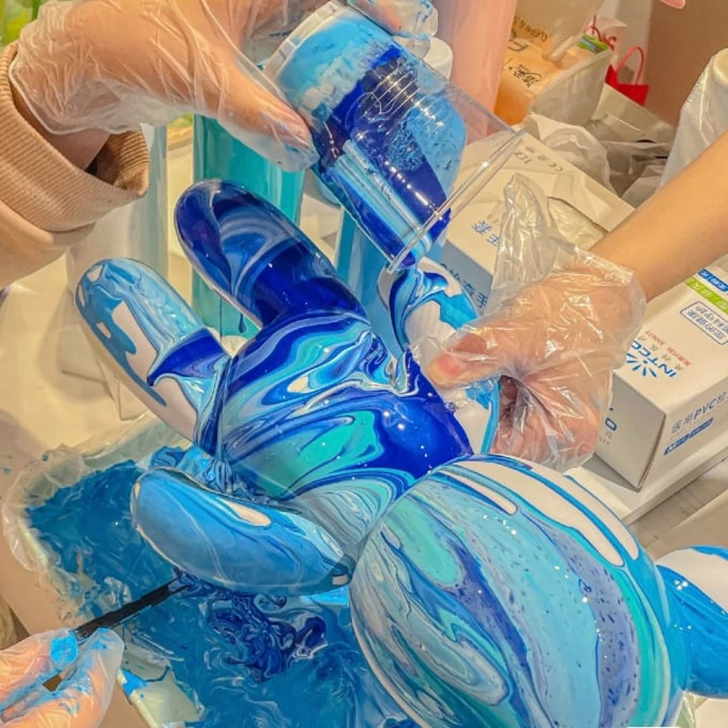 Person dumping paint on bear