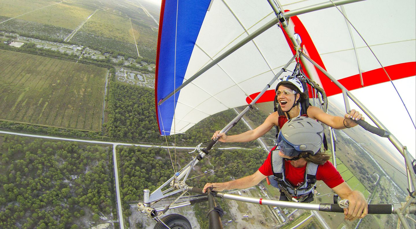 Two people hang gliding