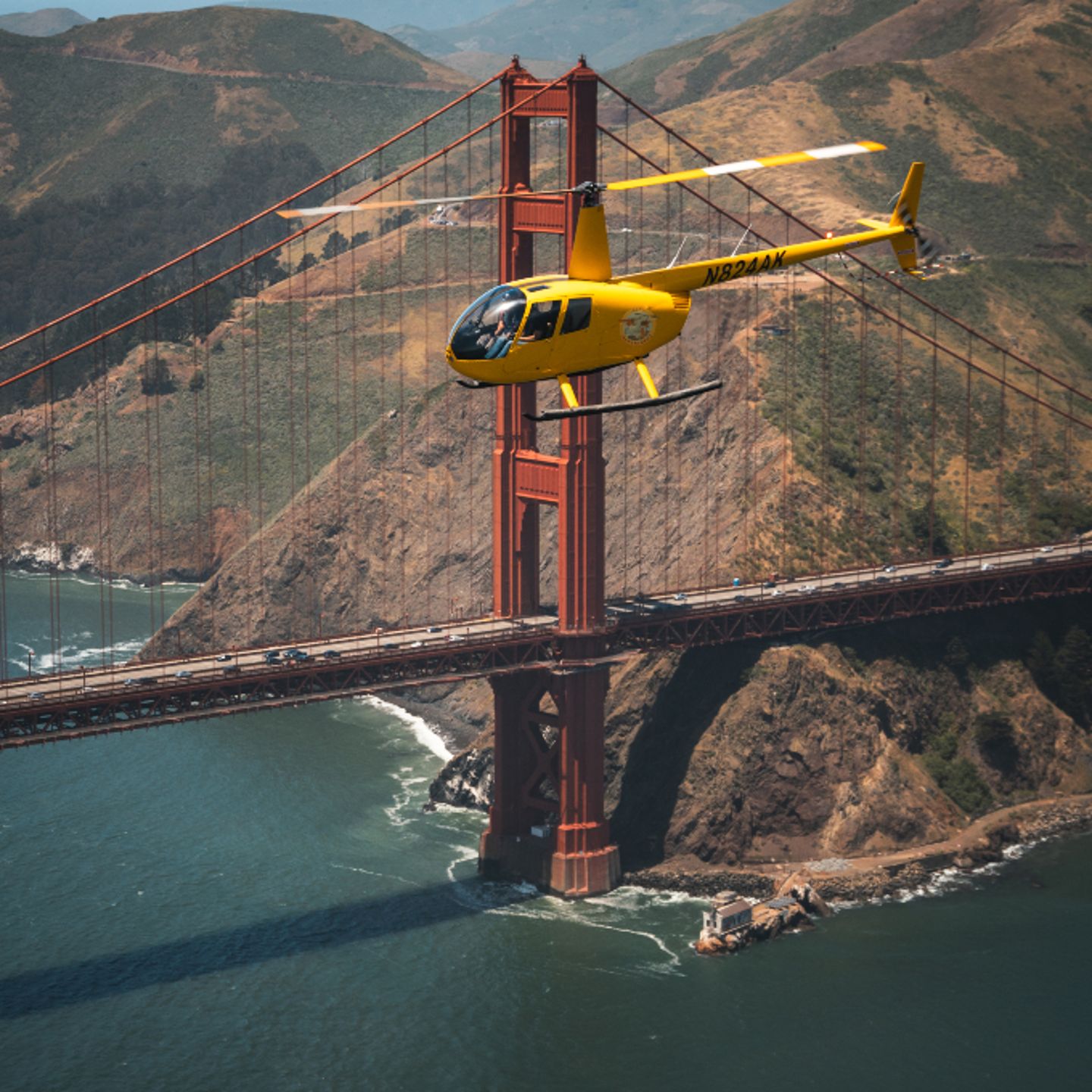 Helicopter near mountains and bridge