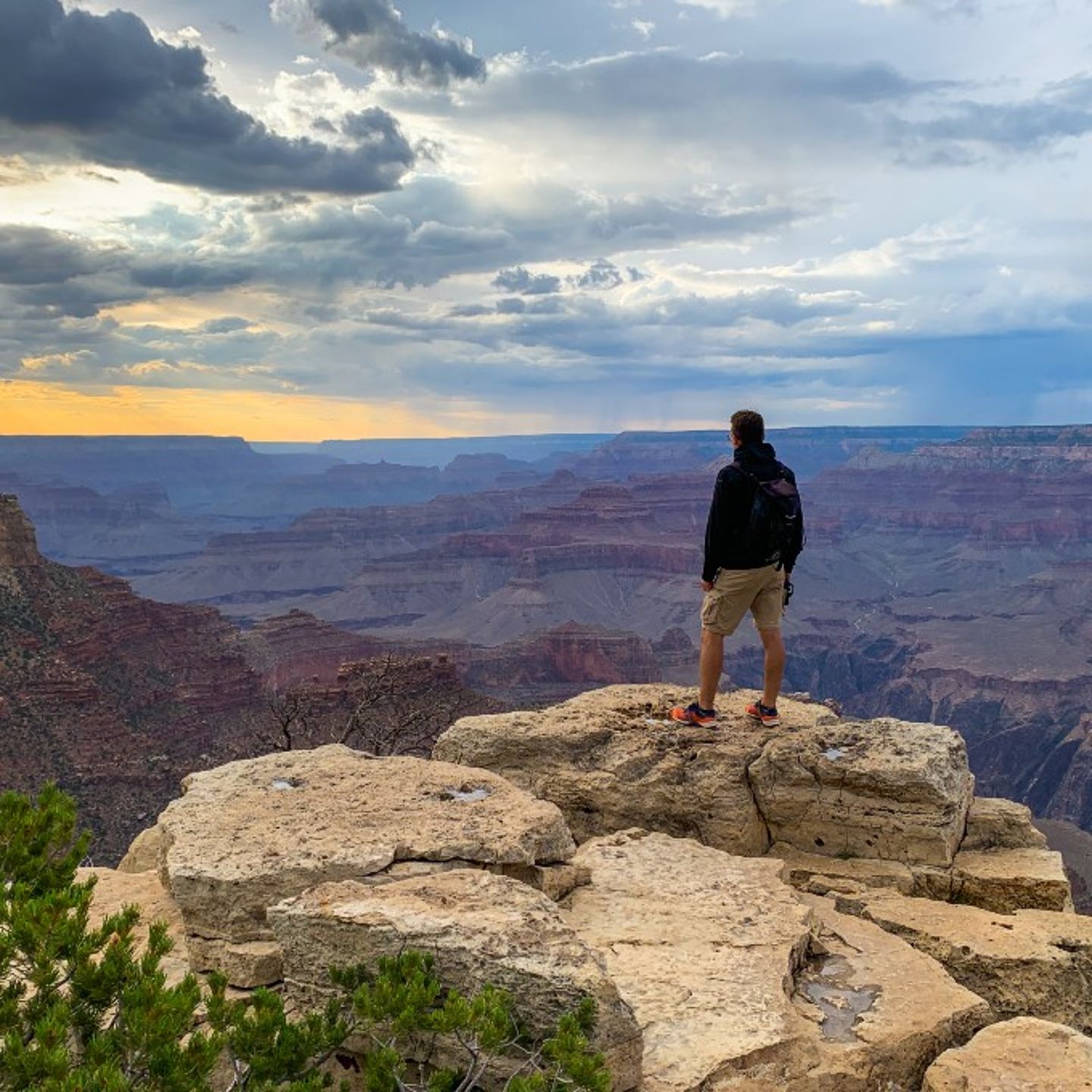 Man looking at view from rock
