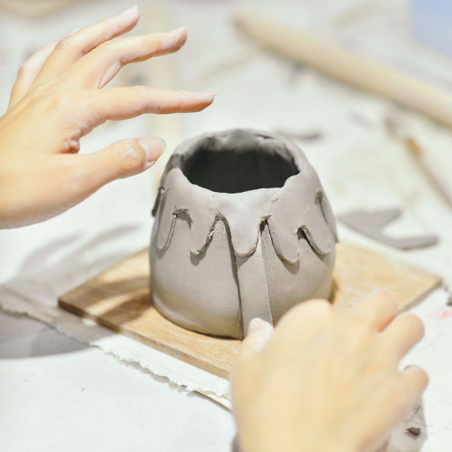 Person working with clay