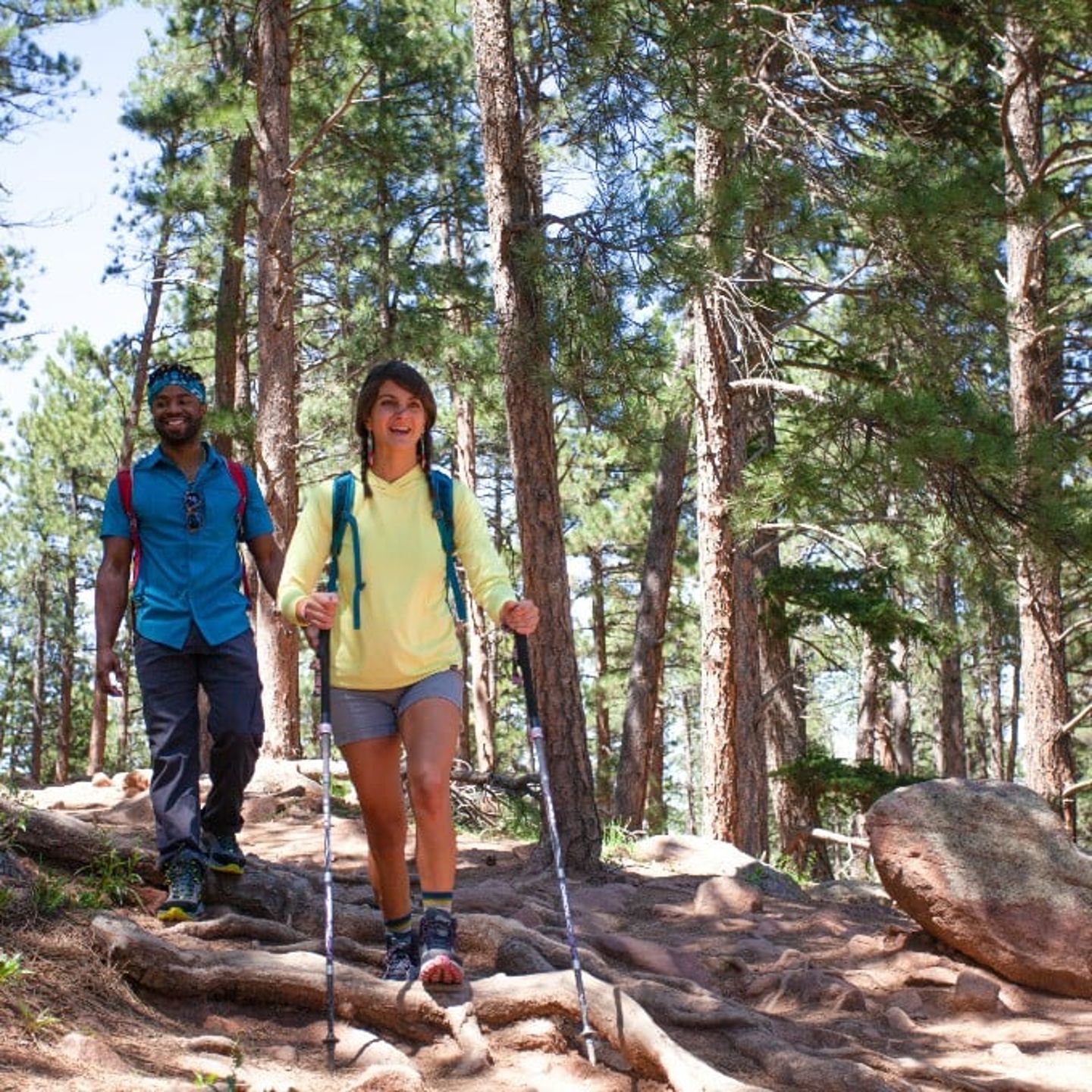Two people hiking through forest