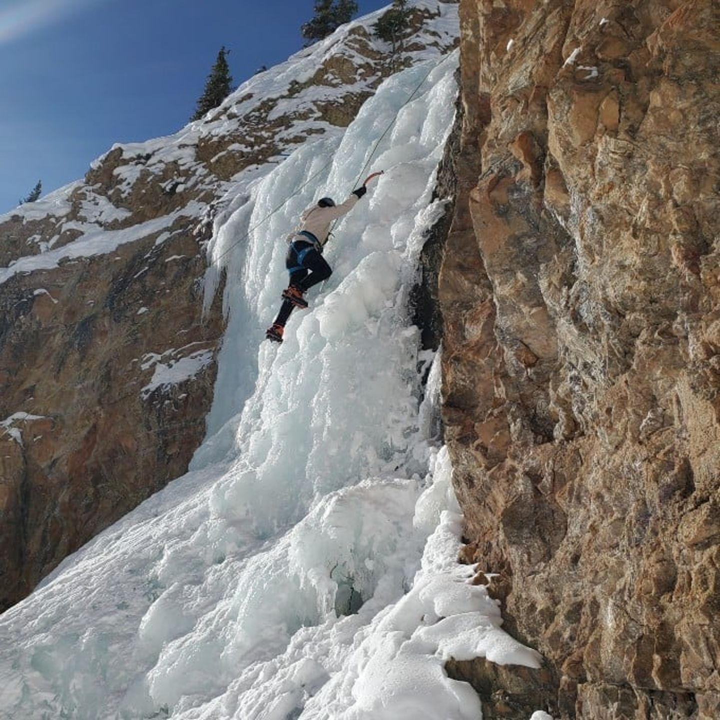 Person climbing up ice mountain