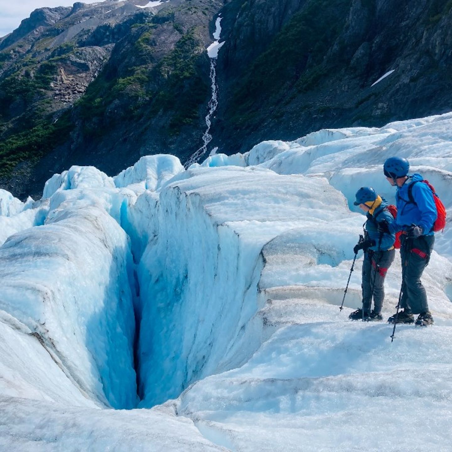 Two People Looking at Ice Formation