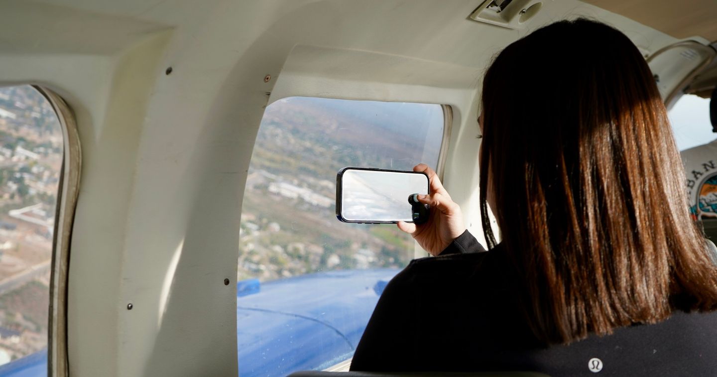 Woman taking pictures on flight