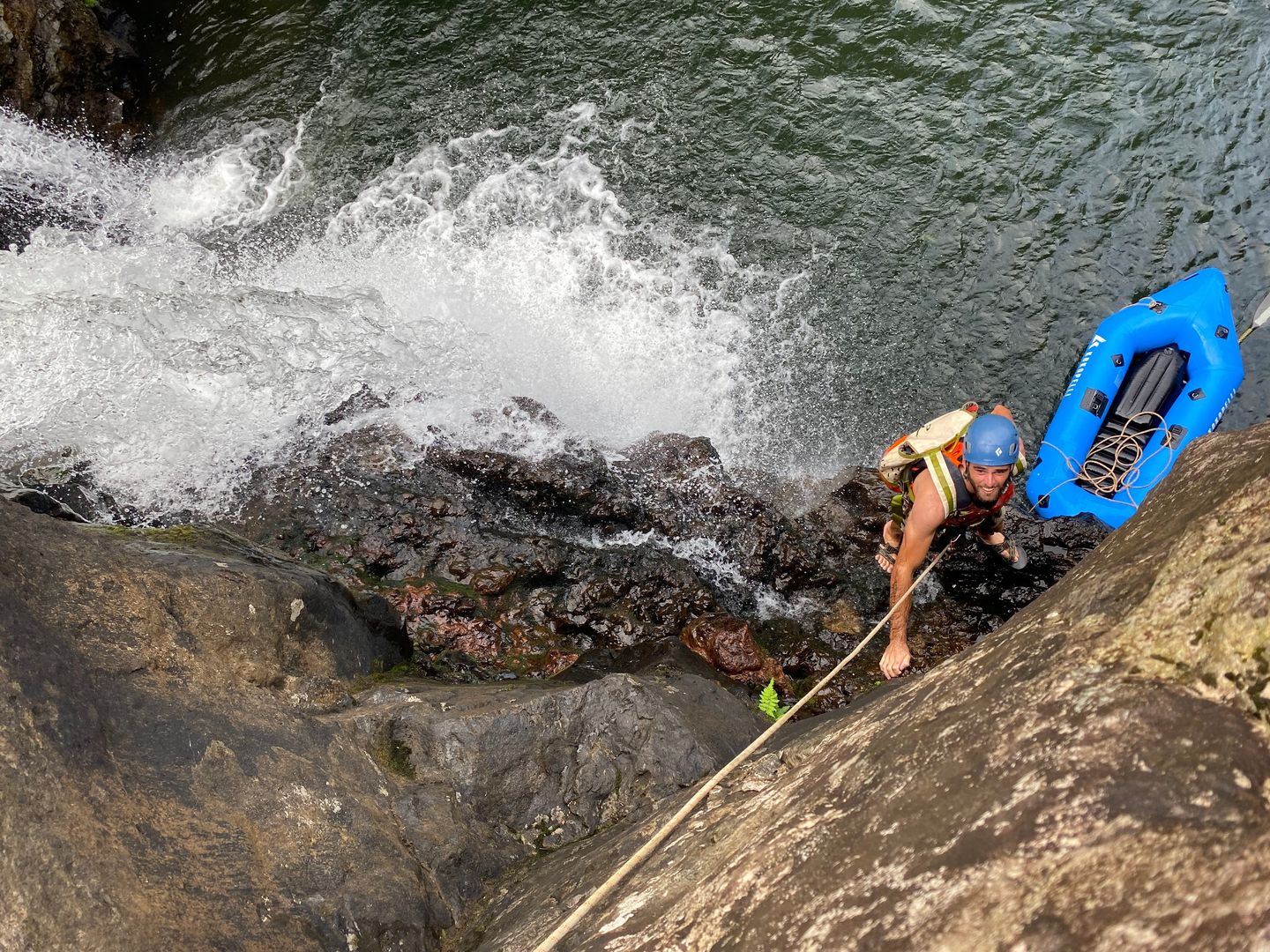Man climbing waterfall