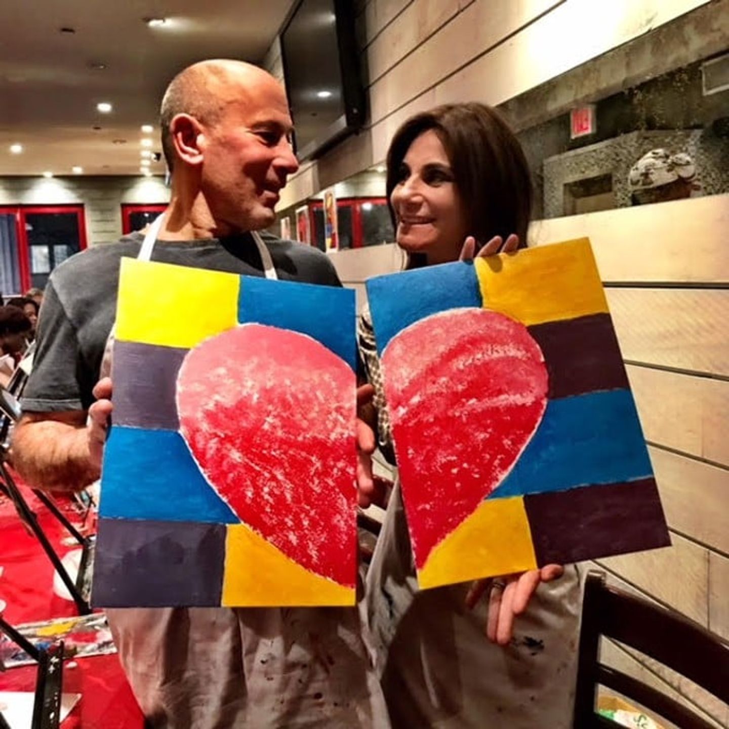 Couple Holding up Finished Hearts