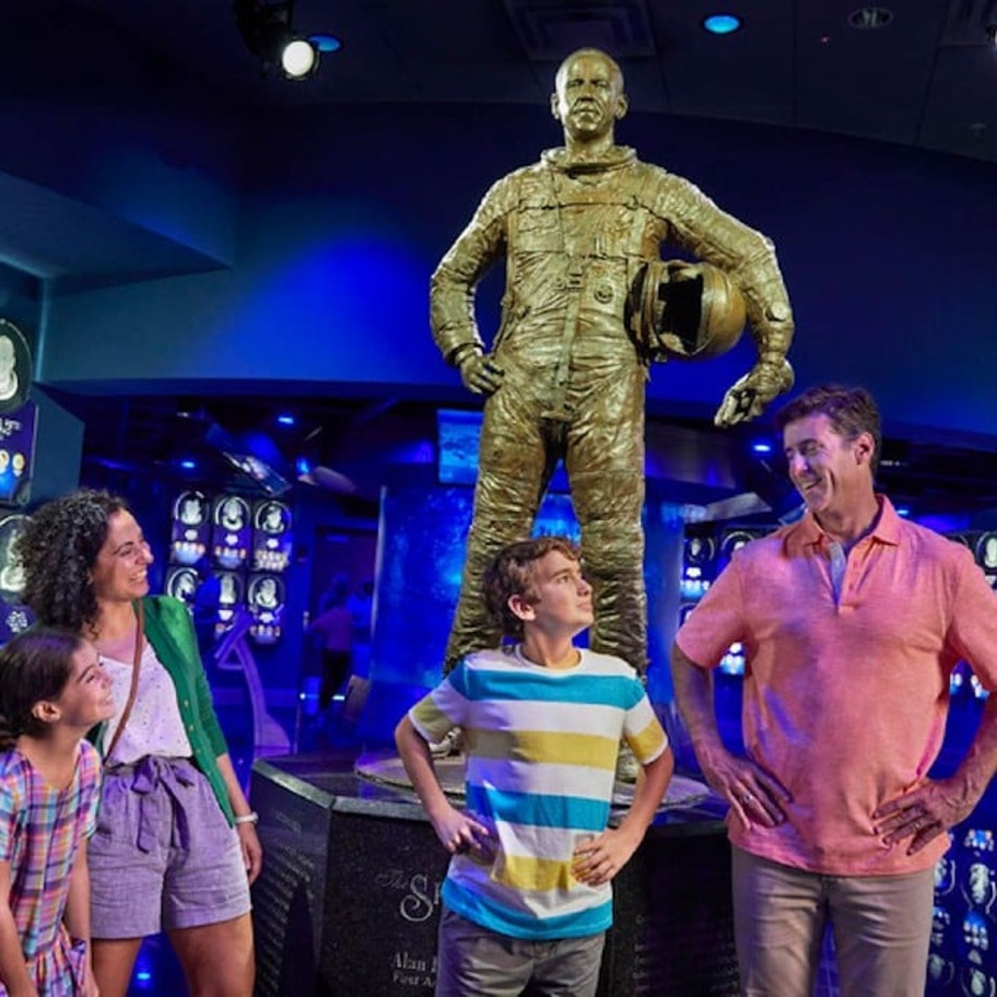 Family posing with statue