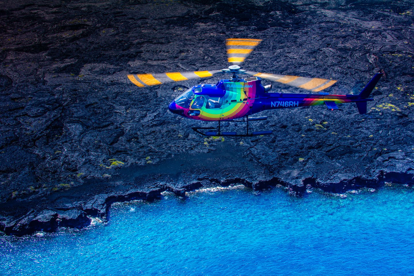 Rainbow helicopter over coast
