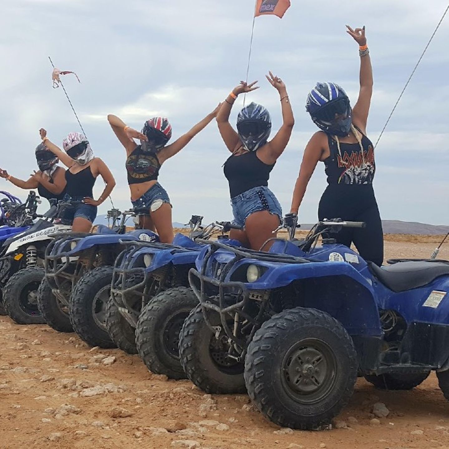 Group posing on ATV's