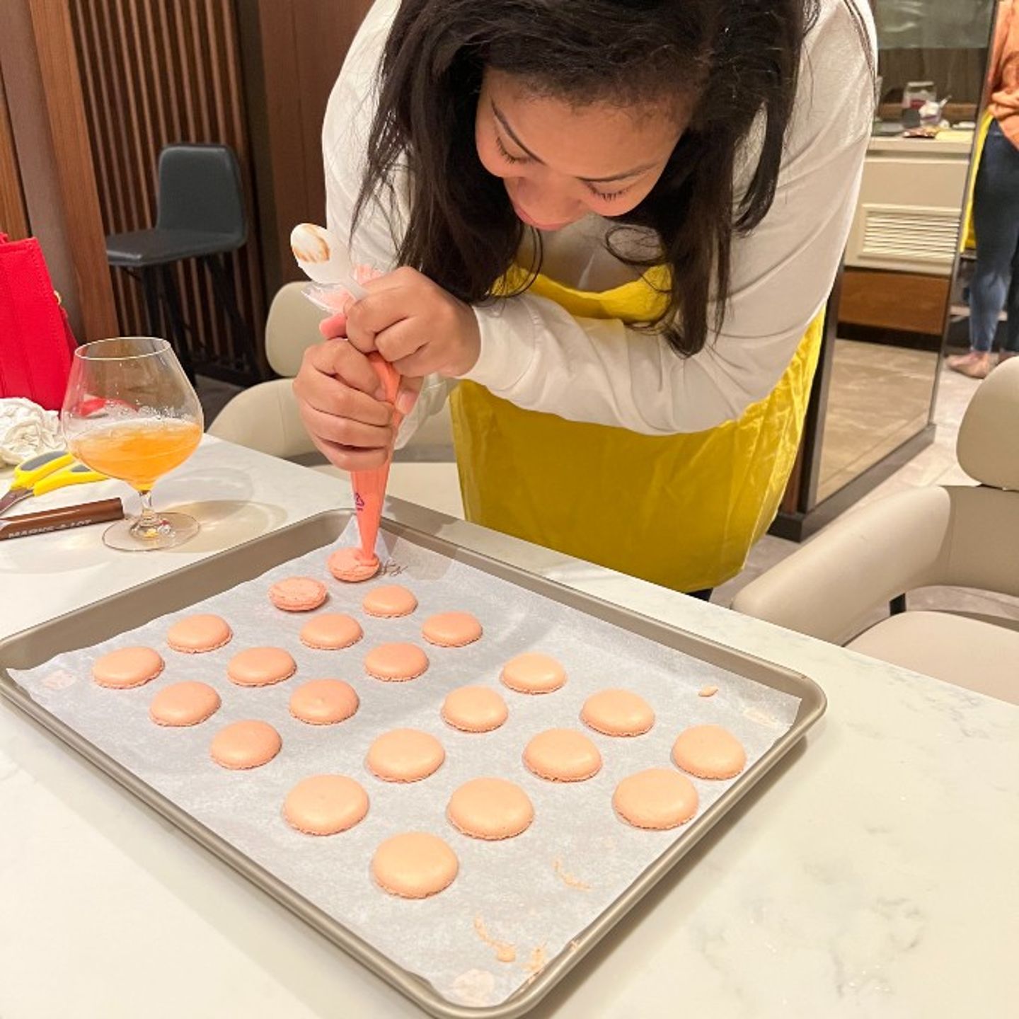 Woman piping macarons