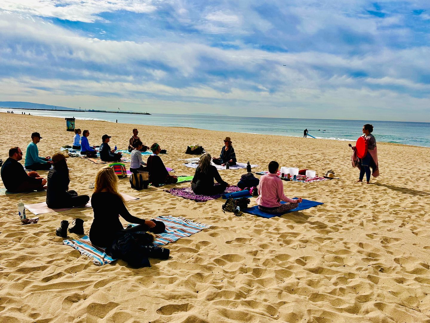 Class sitting on beach