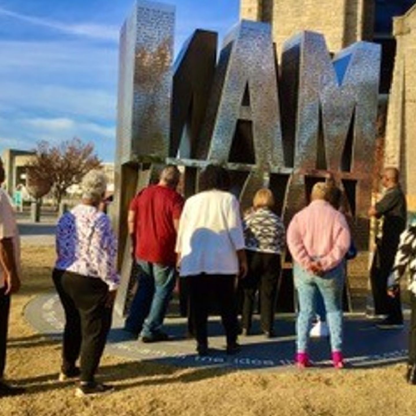 Group Standing in Front of Art