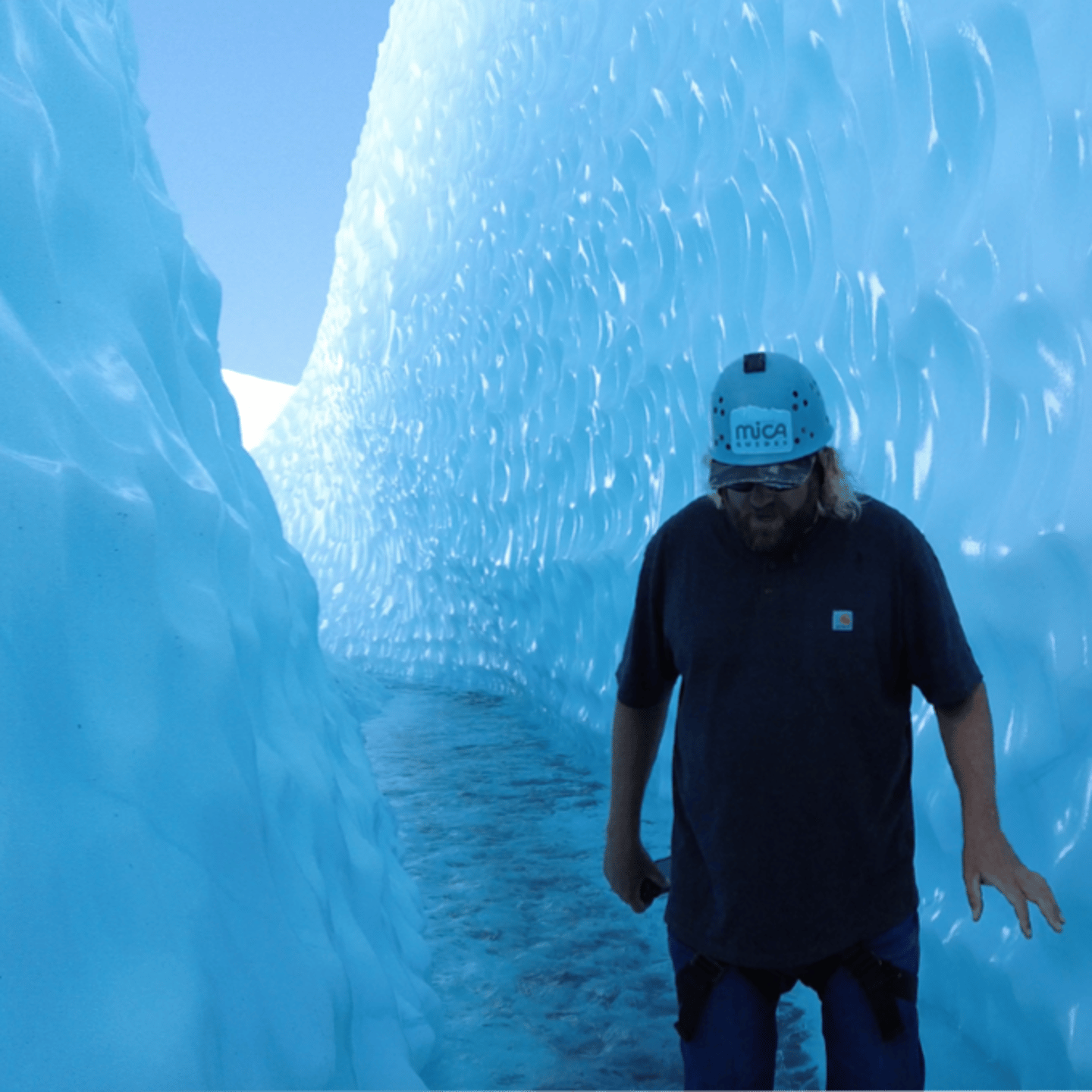 Man Walking Through Ice Cave