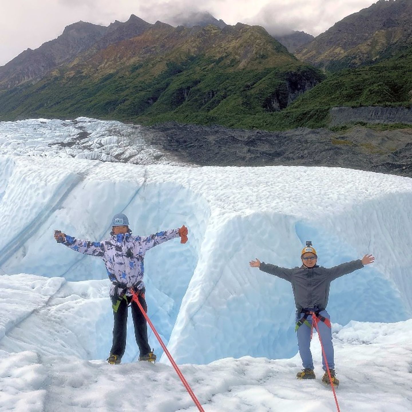 Two People Posing in front of Mountains