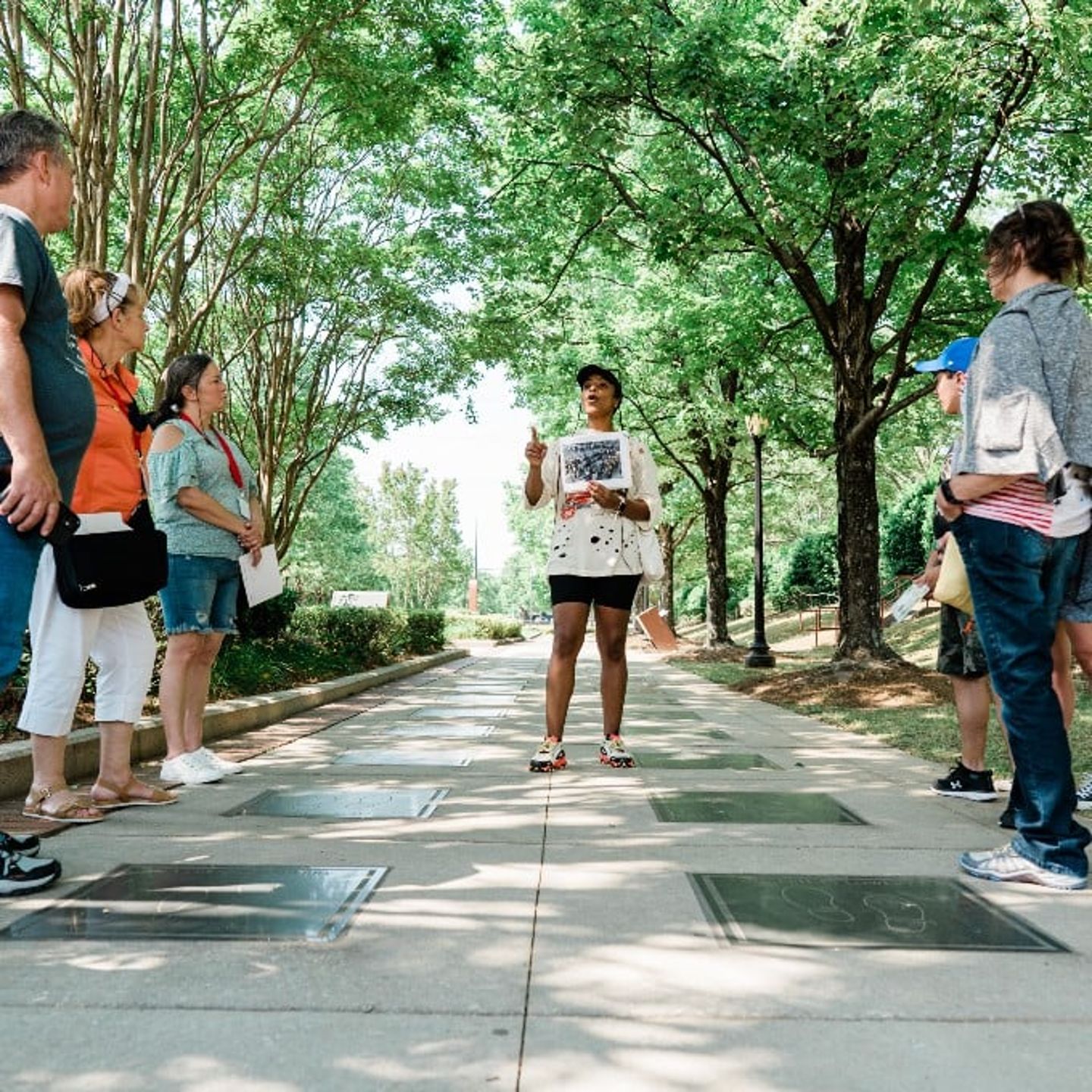 Tour guide sharing facts with group