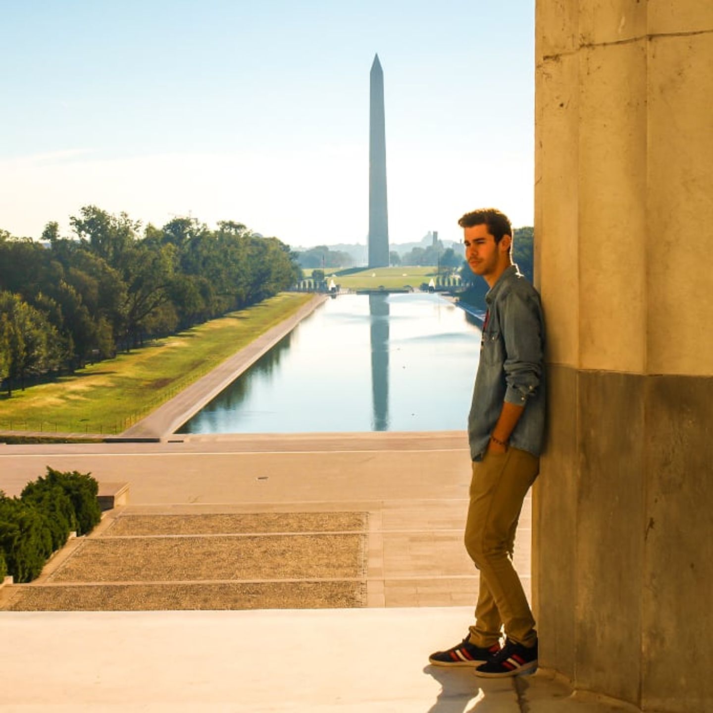 Man posing in front of monument