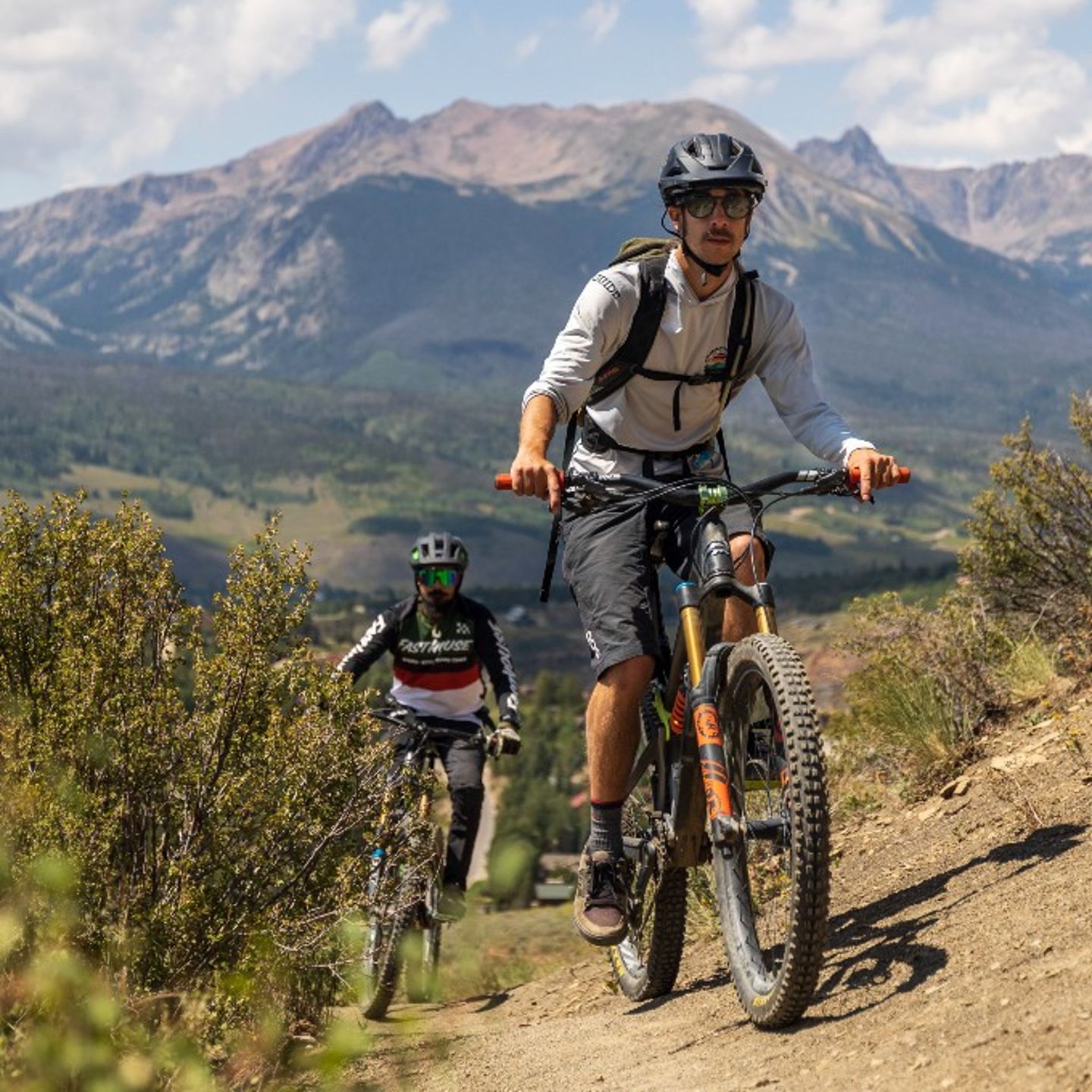 Two people riding up mountain